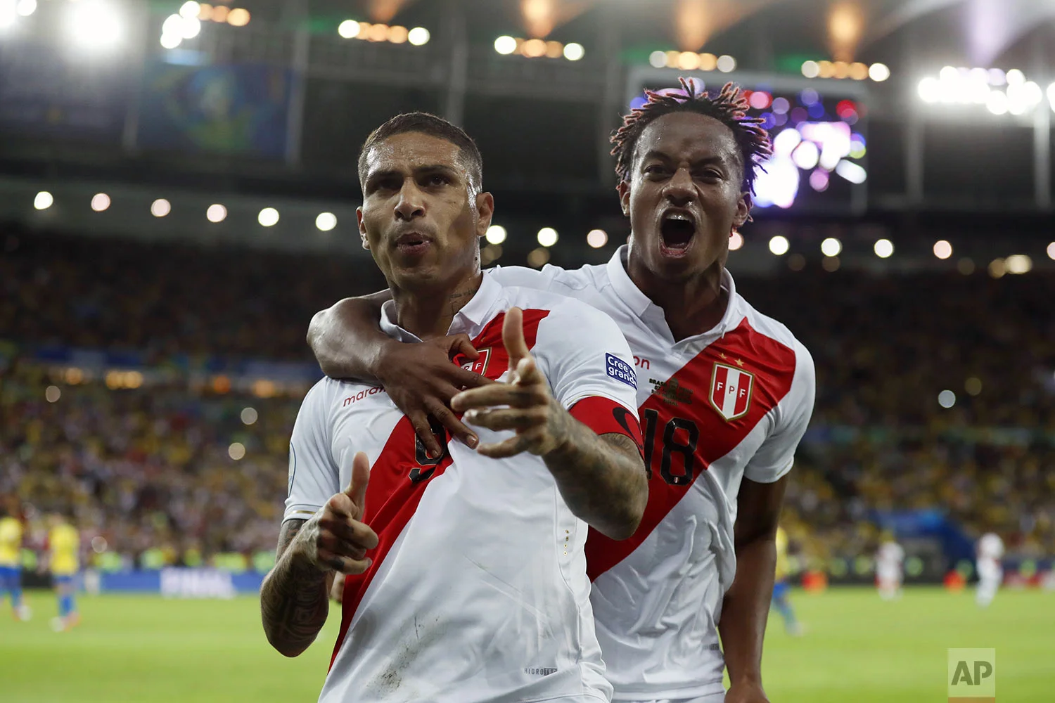 Peru's Paolo Guerrero, left, celebrates with teammate Andre Carrillo, after scoring a penalty kick against Brazil during the final soccer match of the Copa America at Maracana stadium in Rio de Janeiro, Brazil, Sunday, July 7, 2019. (AP Photo/Victor R. Caivano)