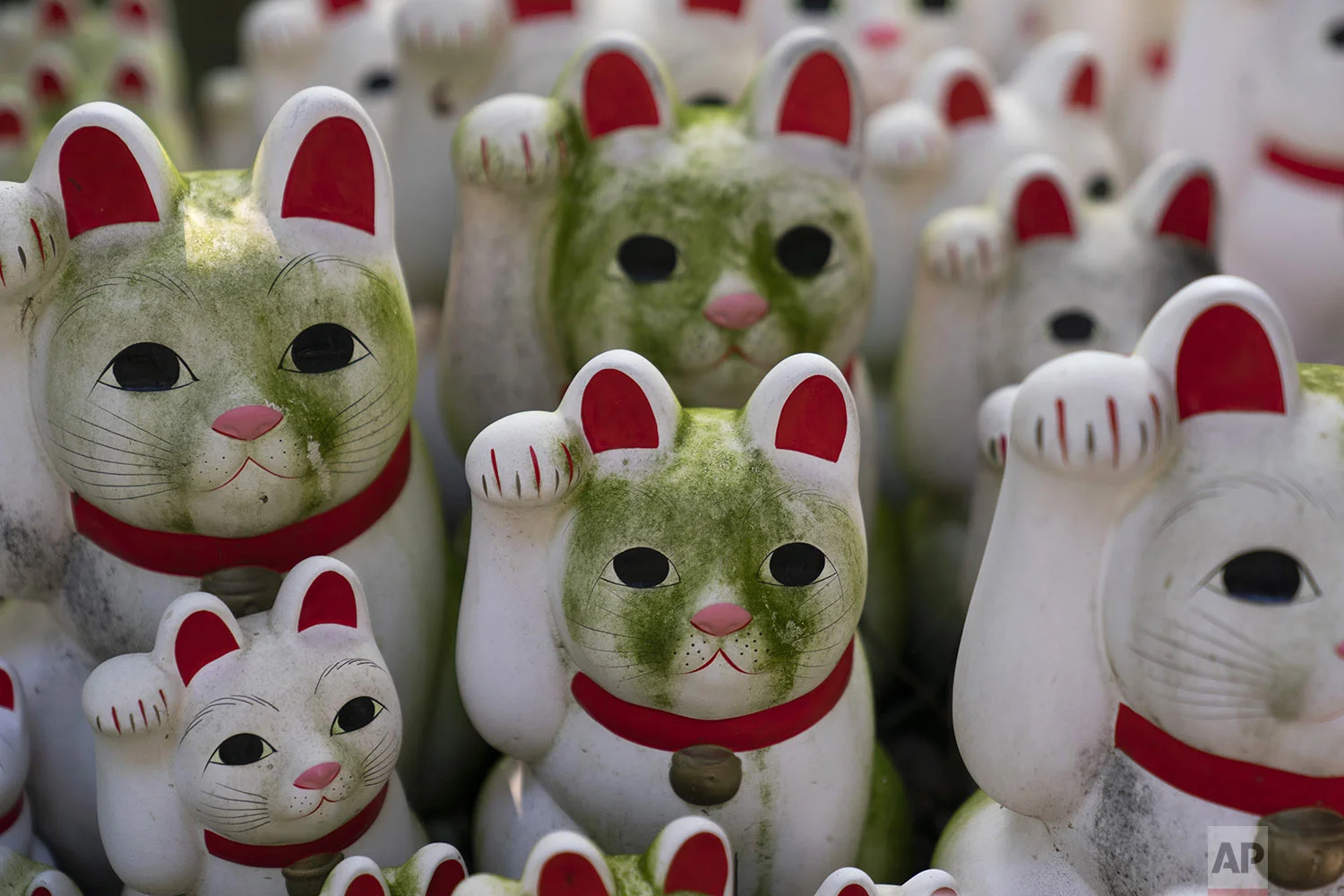 Stained beckoning cat figurines are seen at Gotokuji Temple in Tokyo, Tuesday, June 25, 2019. (AP Photo/Jae C. Hong)