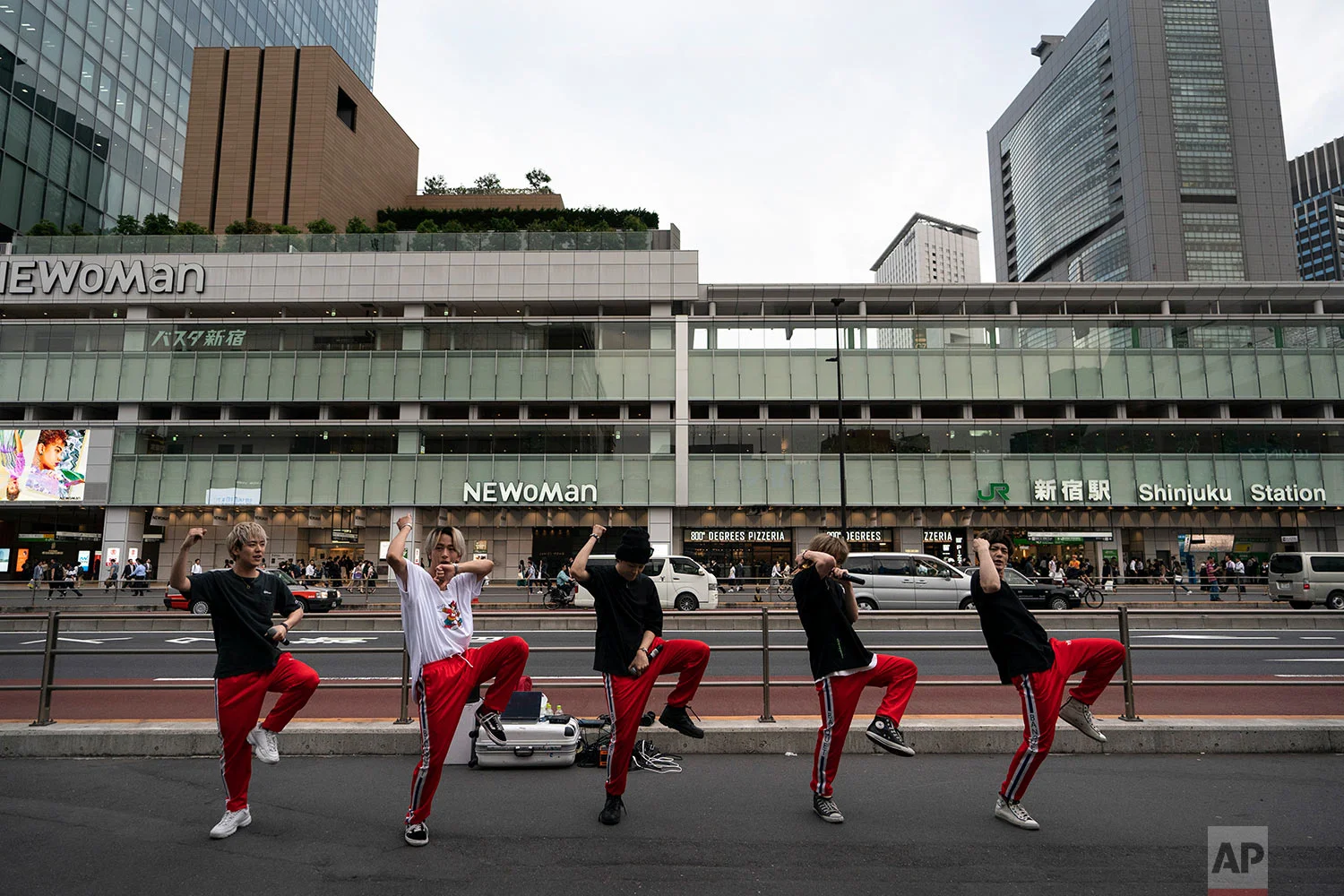 A Japanese dance and vocal group called Banquet performs on the street outside Shinjuku Station in Tokyo, June 4, 2019. (AP Photo/Jae C. Hong)