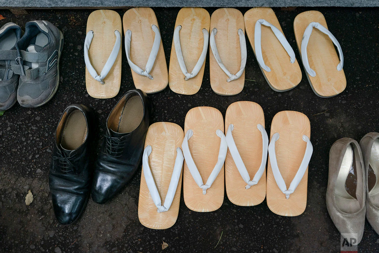 Traditional Japanese footwear called zori are seen next to sneakers and dress shoes during a kendo competition in Tokyo, June 8, 2019. (AP Photo/Jae C. Hong)