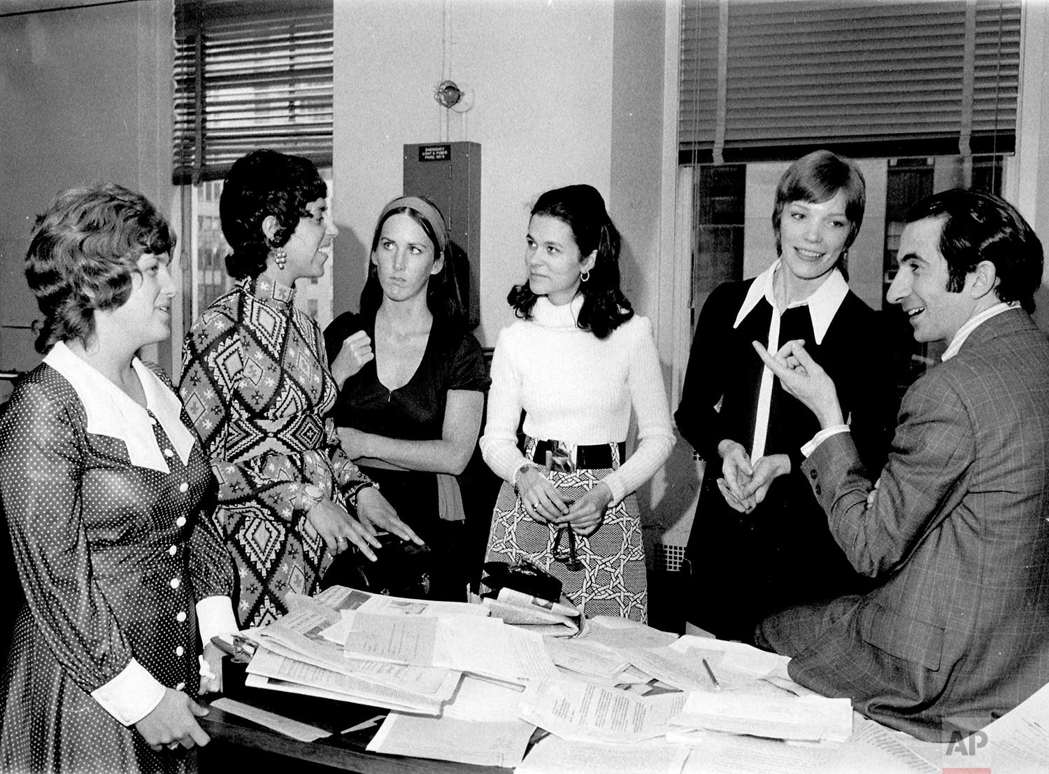AP newswomen were briefed by AP Managing Editor Lou Boccardi, during an orientation visit to the AP General Office in New York. AP World, the employee magazine, will announce in its next issue that the term "newswoman" will be used in the future to describe women reporters. Heretofore male and female writers all were classified as "newsman." From left: Jackie Snyder, Pittsburgh bureau; Debby Rankin, Chicago; Janet Bataile, Des Moines; Mary Gordon, Newark, Nancy Shipley, Nashville and Bocccardi, 1971. (AP Photo/Corporate Archives)