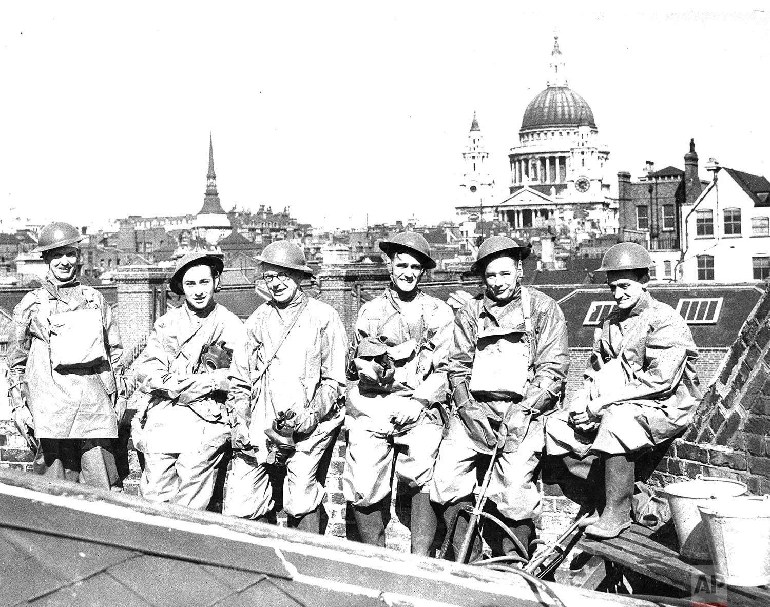 Members of the AP London staff have their own air raid protection squad and here they are shown going through their first full dress parade on May 16, 1940 on the roof of the Associated Press building. They are, left to right, I. A. Milligan, C. Michaels, K. C. Boxall, L. I. Jones, G. Selkirk and G. Angus. (AP Photo/Corporate Archives)