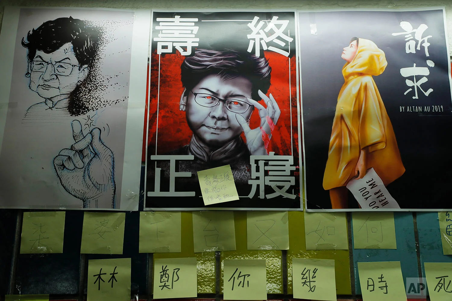 Post-it notes and a caricature of Hong Kong leader Carrie Lam are seen on their version Lennon Wall in Hong Kong, July 12, 2019. (AP Photo/Kin Cheung)