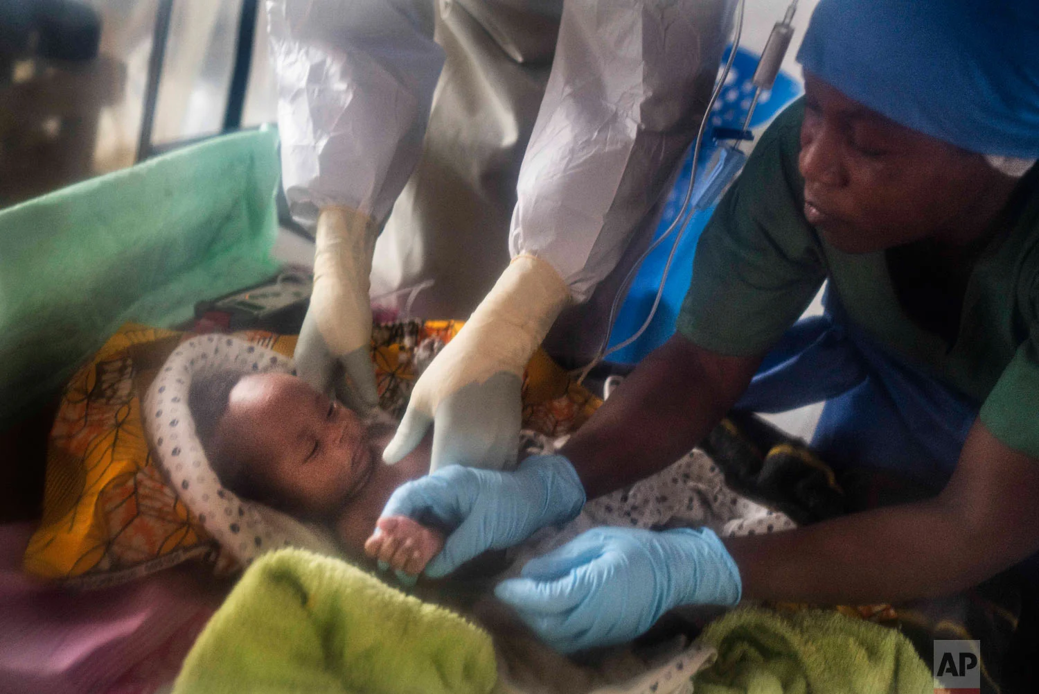 Health workers treat Amani Musanga, 6-weeks-old, at an Ebola treatment center in Beni, Congo, July 15 2019. (AP Photo/Jerome Delay)