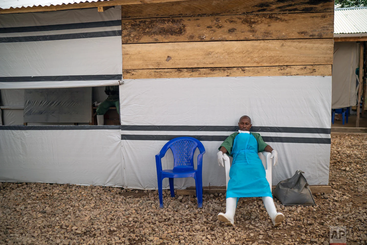 A health workers rests at the end of his shift at an Ebola treatment center in Beni, Congo, July 16, 2019. (AP Photo/Jerome Delay)