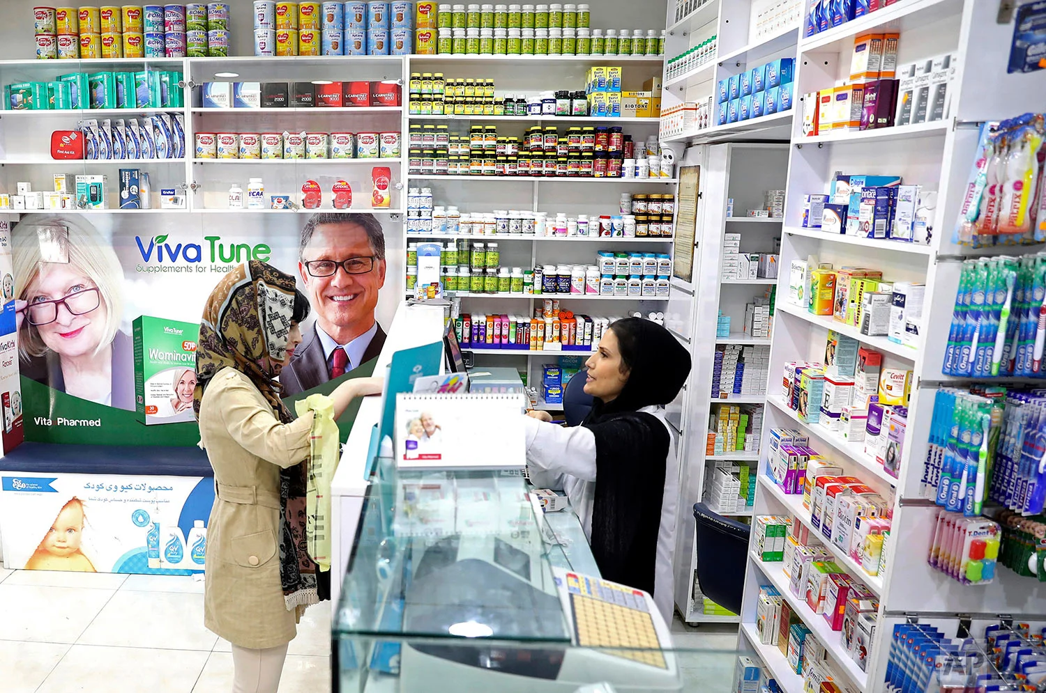 A pharmacist talks with a customer in a drugstore in downtown Tehran, Iran. (AP Photo/Ebrahim Noroozi)