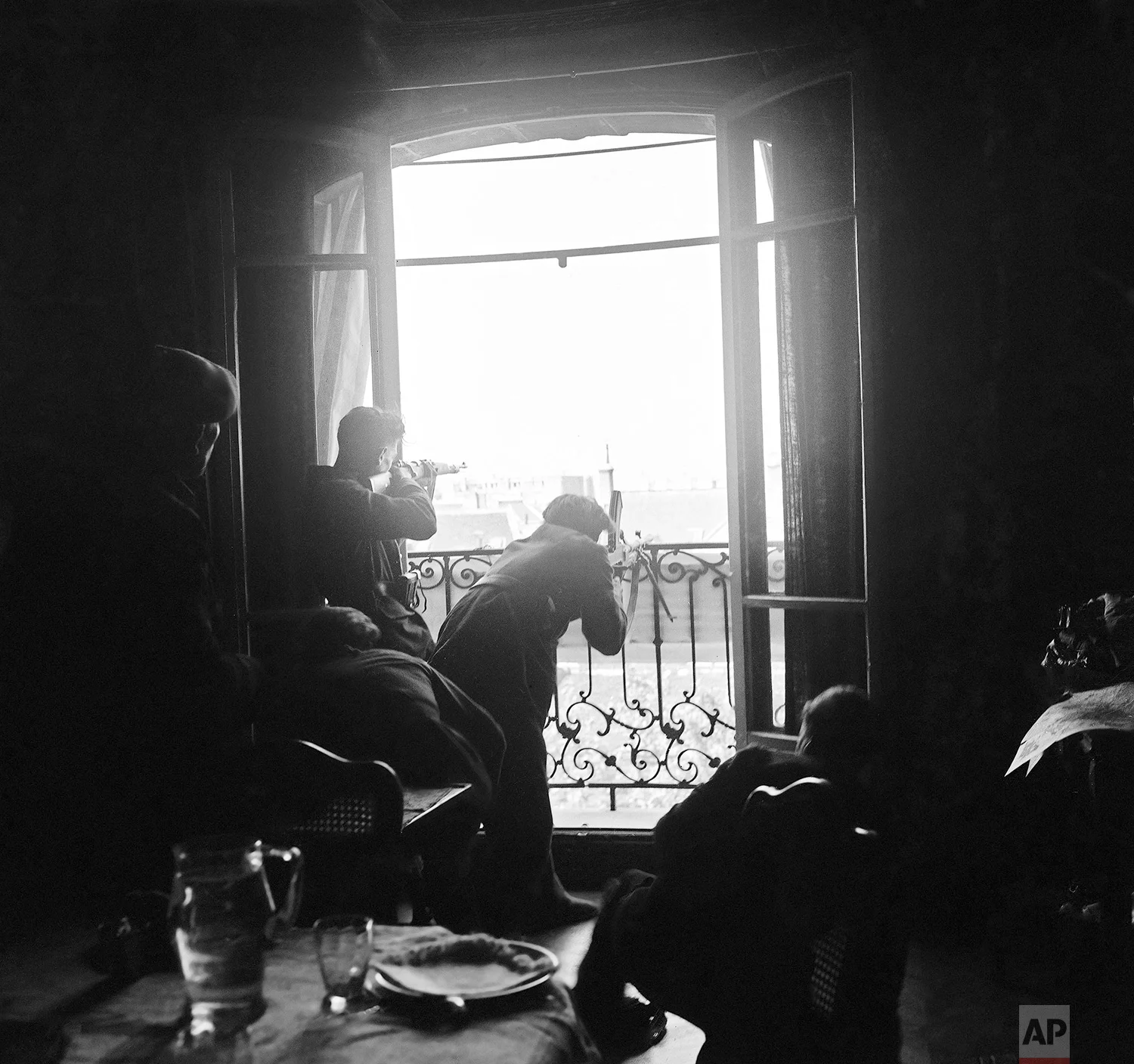 Members of the French Forces of the Interior (FFI) shoot at German snipers from a window in Paris on August 26, 1944. (AP Photo/Peter J. Carroll)