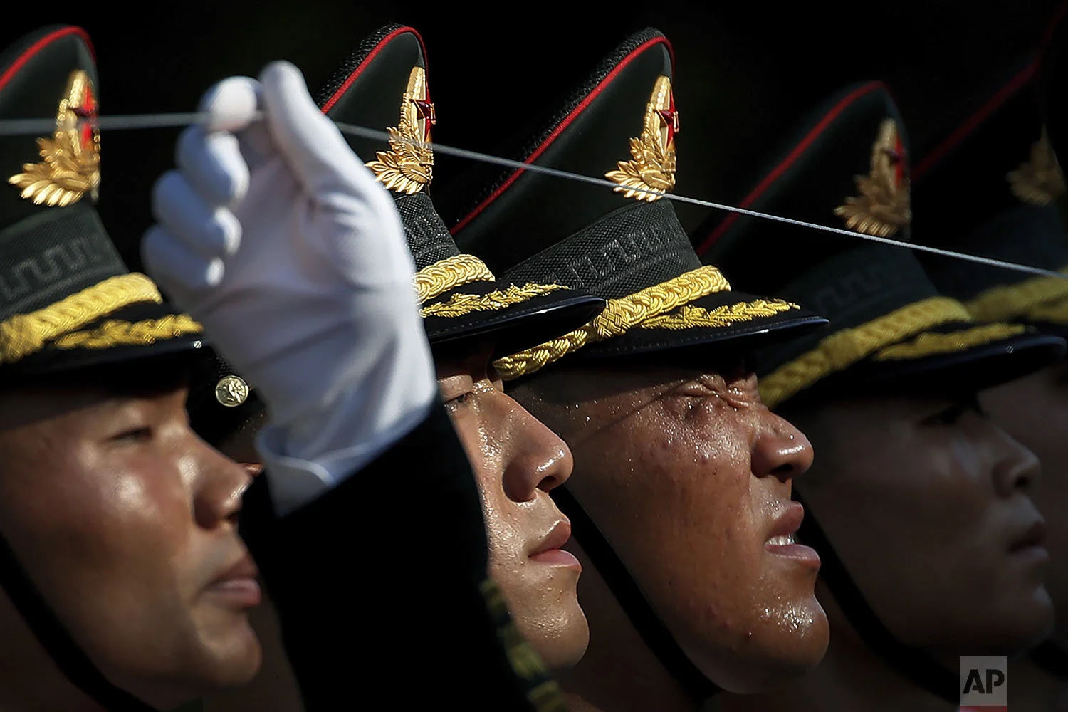 A member of an honor guard reacts as he and his comrades prepare for a welcome ceremony for visiting Colombia's President Ivan Duque, at the Great Hall of the People in Beijing, Wednesday, July 31, 2019. (AP Photo/Andy Wong)