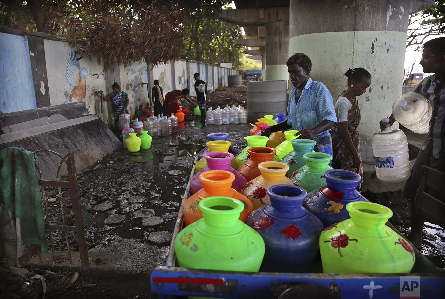 Indians fill drinking water from the taps of water filling depot in Chennai in Southern Indian state of Tamil Nadu, Monday, July 15, 2019. (AP Photo/Manish Swarup)