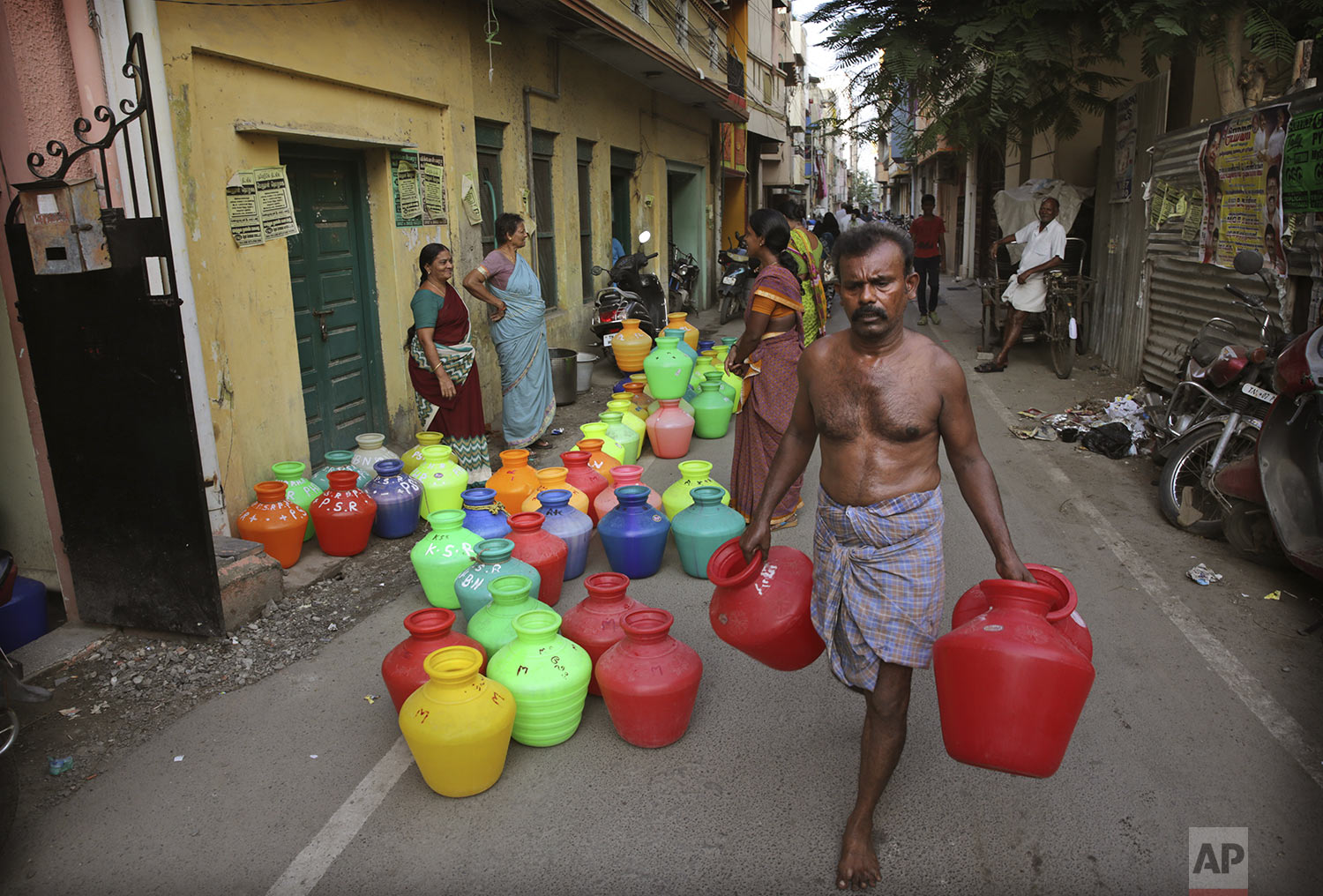 Residents wait for water trucks to arrive in Chennai in Southern Indian state of Tamil Nadu, Monday, July 15, 2019. (AP Photo/Manish Swarup)