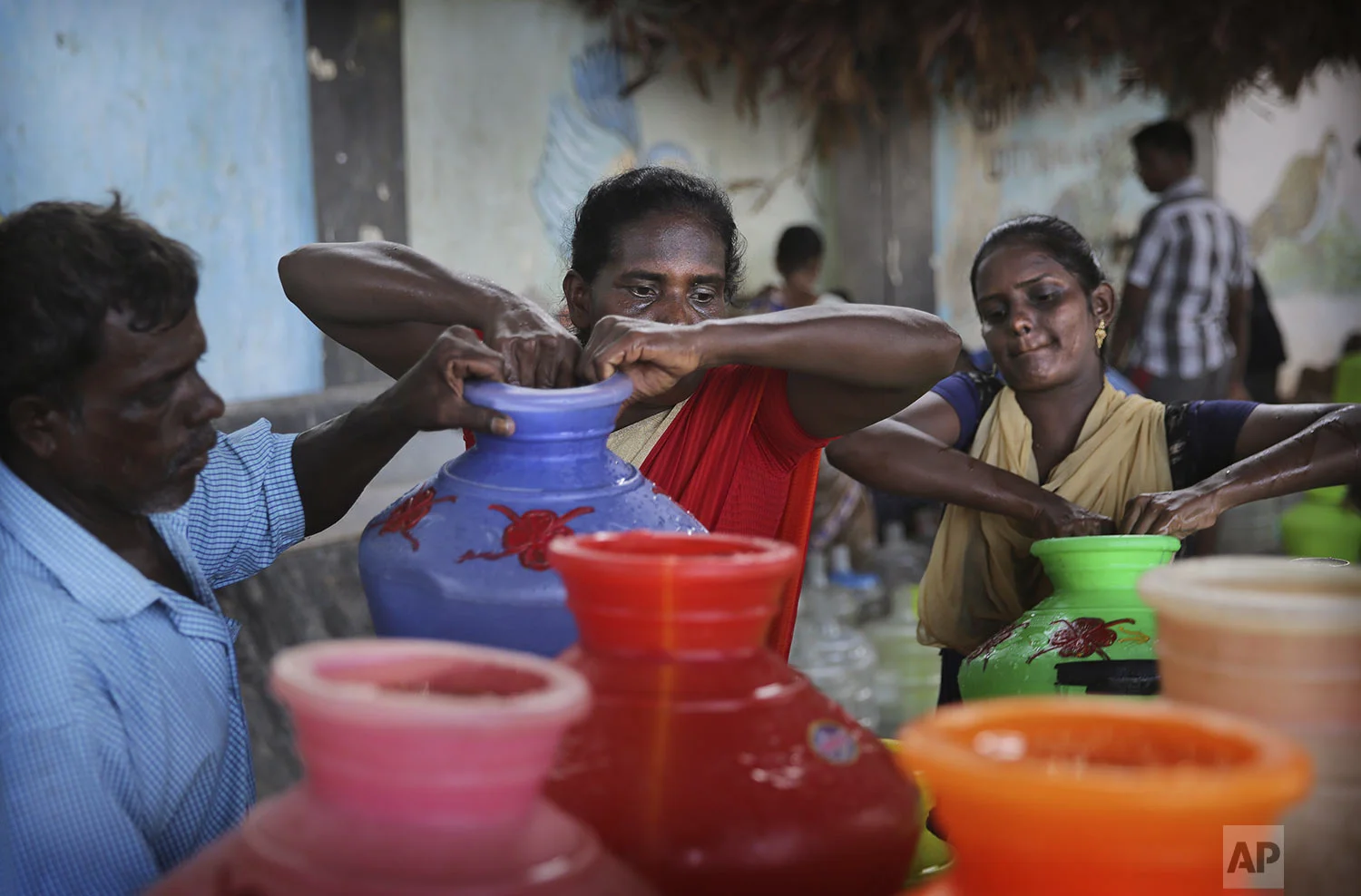 People load drinking water on to their hand cart in Chennai in Southern Indian state of Tamil Nadu, Monday, July 15, 2019. (AP Photo/Manish Swarup)