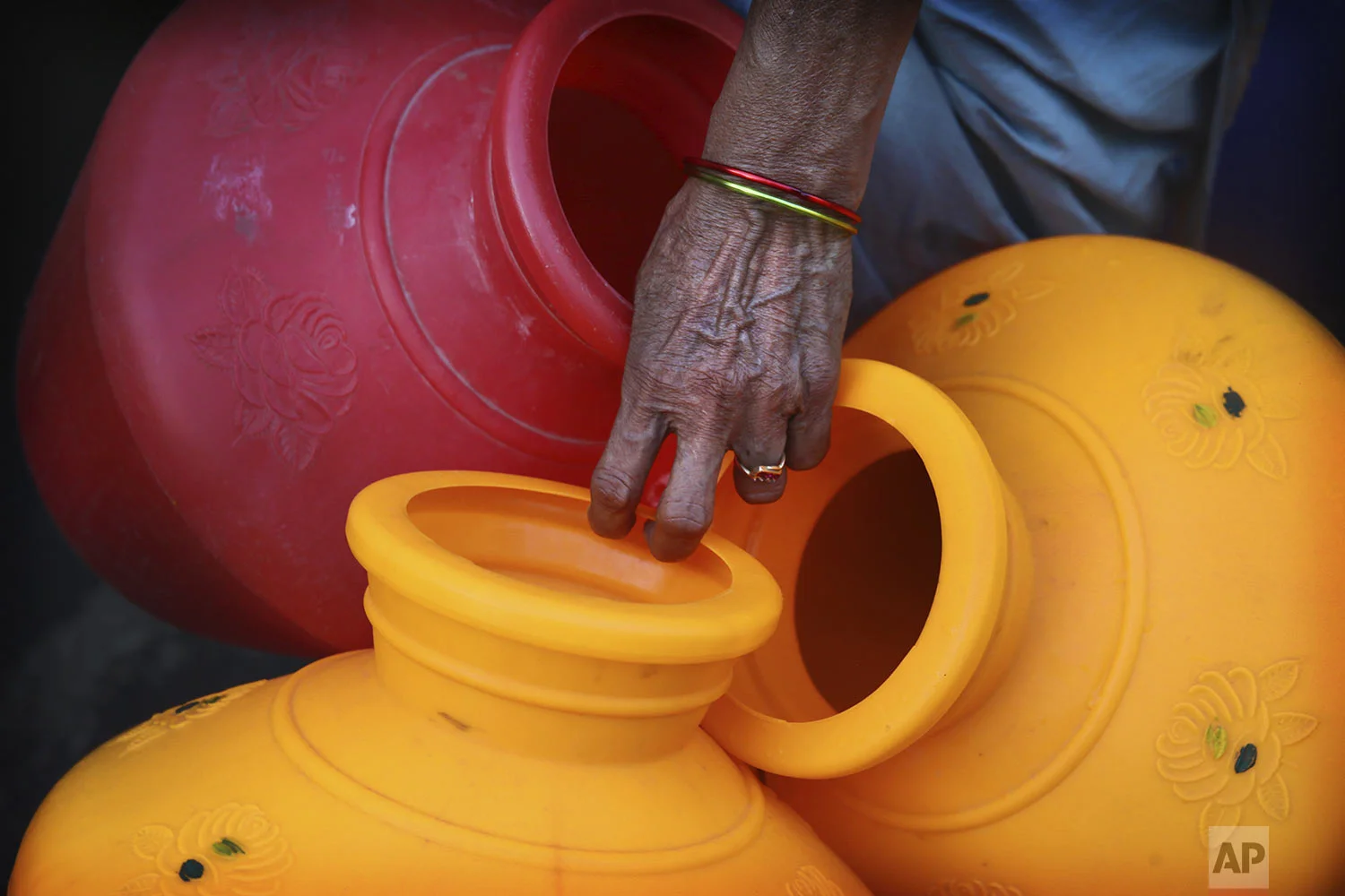 A woman waits for a water truck to arrive in Chennai in Southern Indian state of Tamil Nadu, Monday, July 15, 2019. (AP Photo/Manish Swarup)