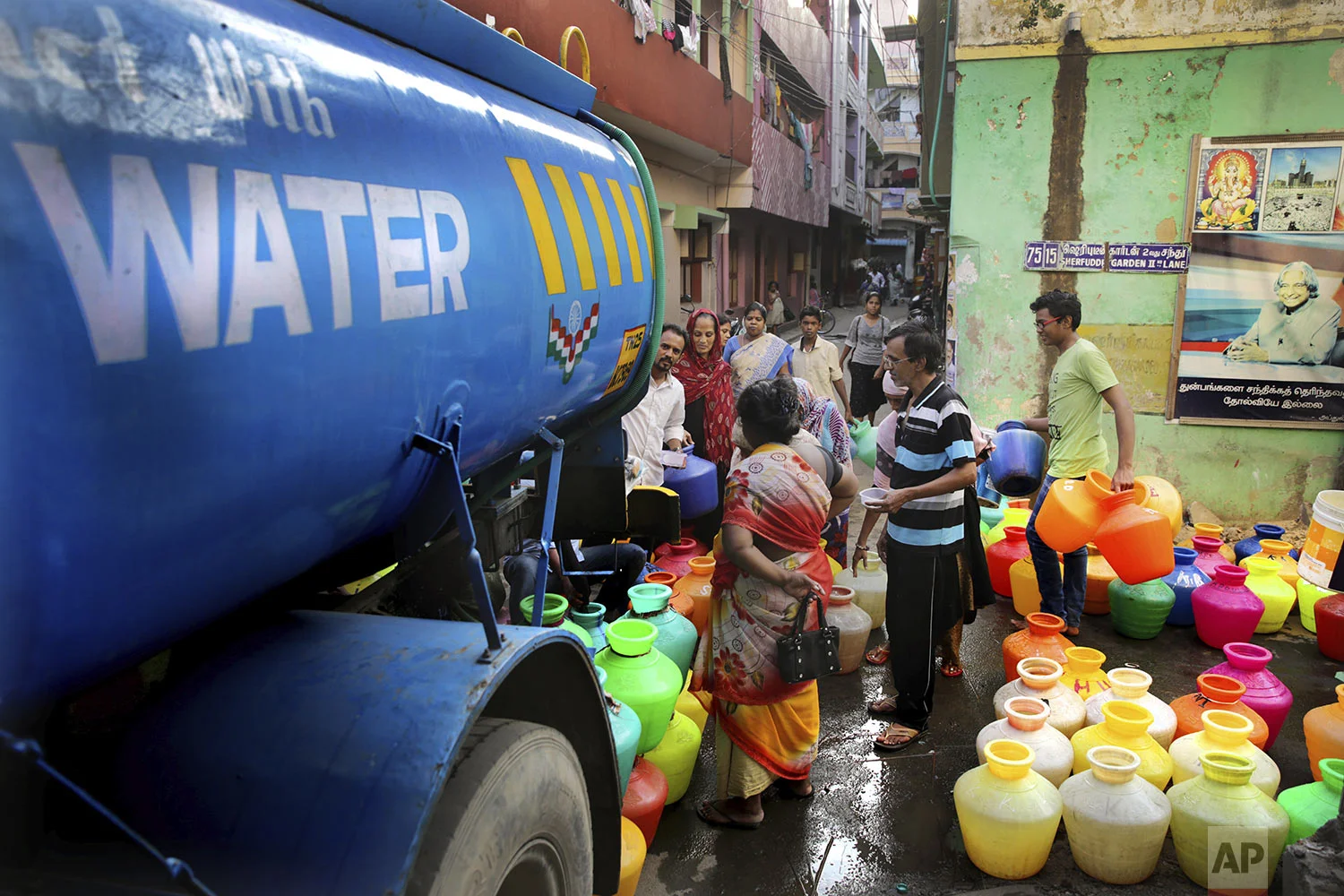 People fill drinking water from a water tanker truck in Chennai in Southern Indian state of Tamil Nadu, Monday, July 15, 2019. (AP Photo/Manish Swarup)