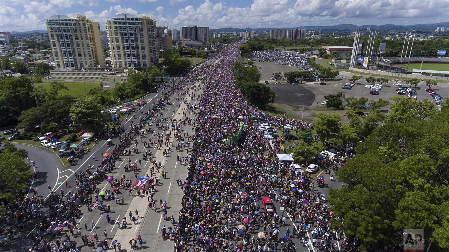 Demonstrators march on Las Americas highway demanding the resignation of governor Ricardo Rossello, in San Juan, Puerto Rico, Monday, July 22, 2019. Protesters are demanding Rossello step down for his involvement in a private chat in which he used profanities to describe an ex-New York City councilwoman and a federal control board overseeing the island's finance. (AP Photo/Gianfranco Gaglione)