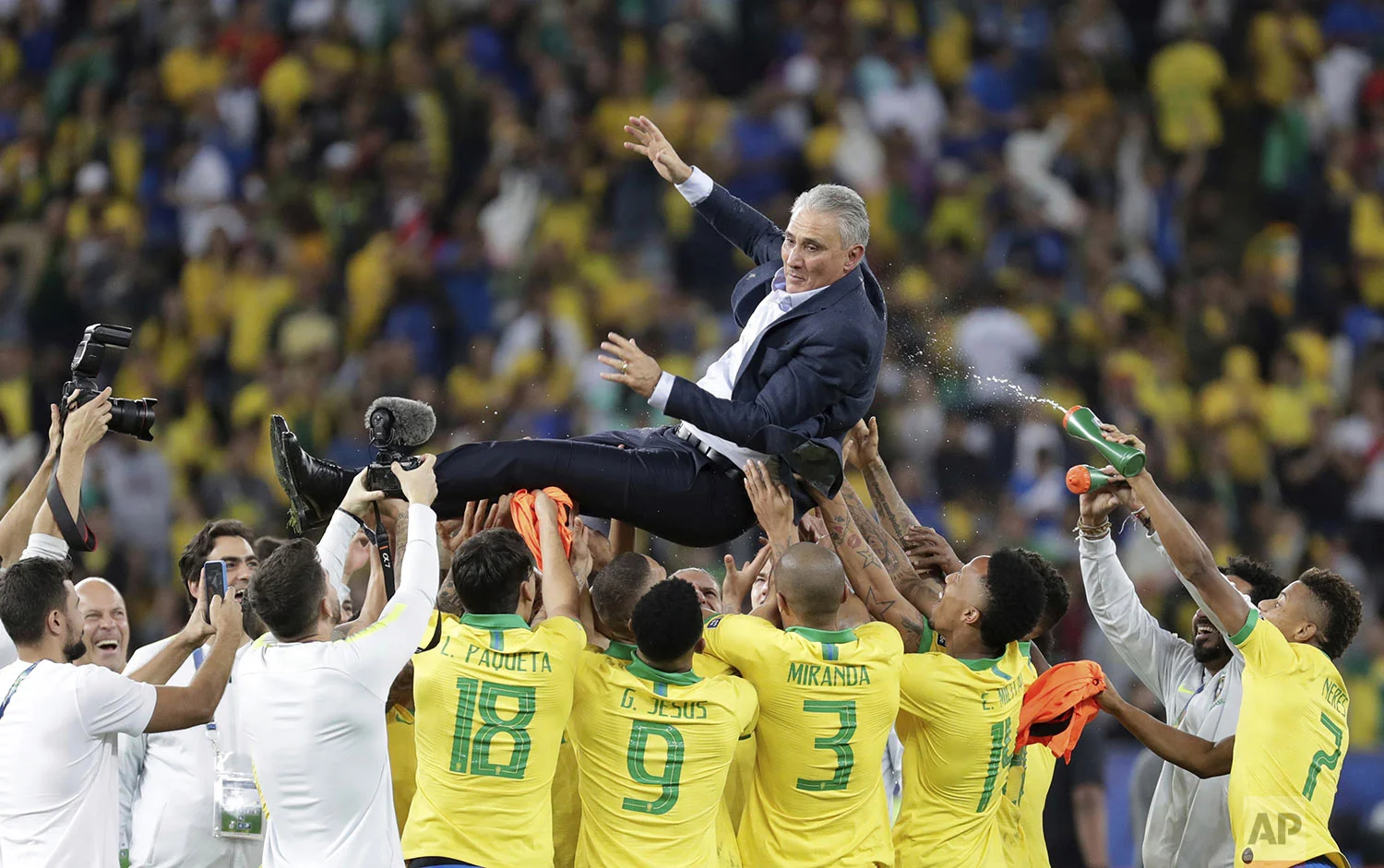 Brazil's coach Tite is thrown in the air by players to celebrate their 3-1 victory over Peru at the end of the final Copa America soccer match at Maracana stadium in Rio de Janeiro, Brazil, Sunday, July 7, 2019. (AP Photo/Leo Correa)