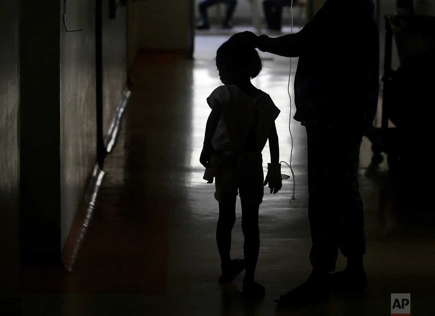 A young dengue patient walks inside the San Lazaro government hospital in Manila, Philippines on Wednesday, Aug. 7, 2019. (AP Photo/Aaron Favila)