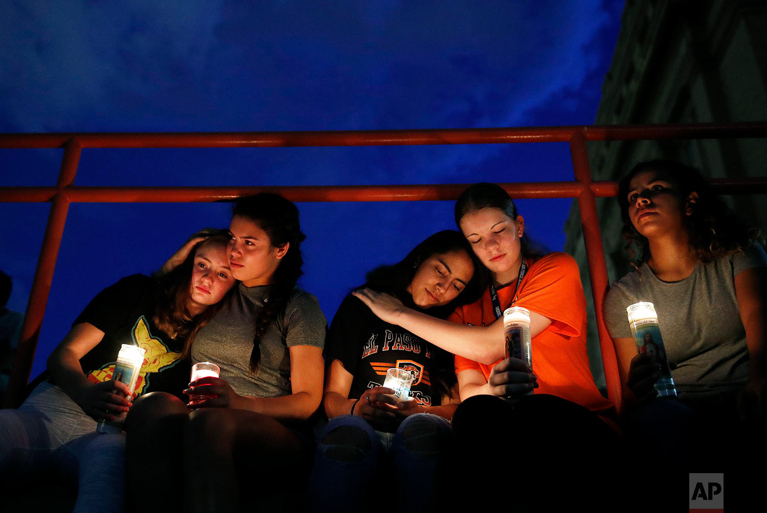  From left, Melody Stout, Hannah Payan, Aaliyah Alba, Sherie Gramlich and Laura Barrios comfort each other during a vigil for victims of the shooting Saturday, Aug. 3, 2019, in El Paso, Texas. A young gunman opened fire in an El Paso, Texas, shopping