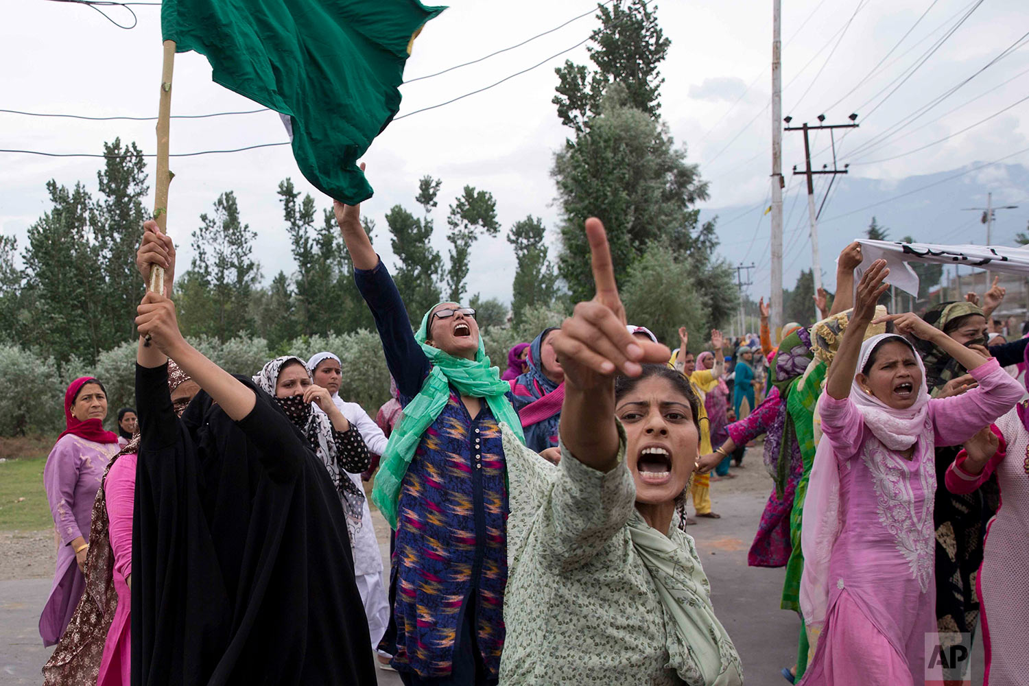  Women shout slogans and march on a street after Friday prayers in Srinagar, Indian controlled Kashmir, Friday, Aug. 9, 2019. A strict curfew in Indian-administered Kashmir in effect for a fifth day was eased Friday to allow residents to pray at mosq