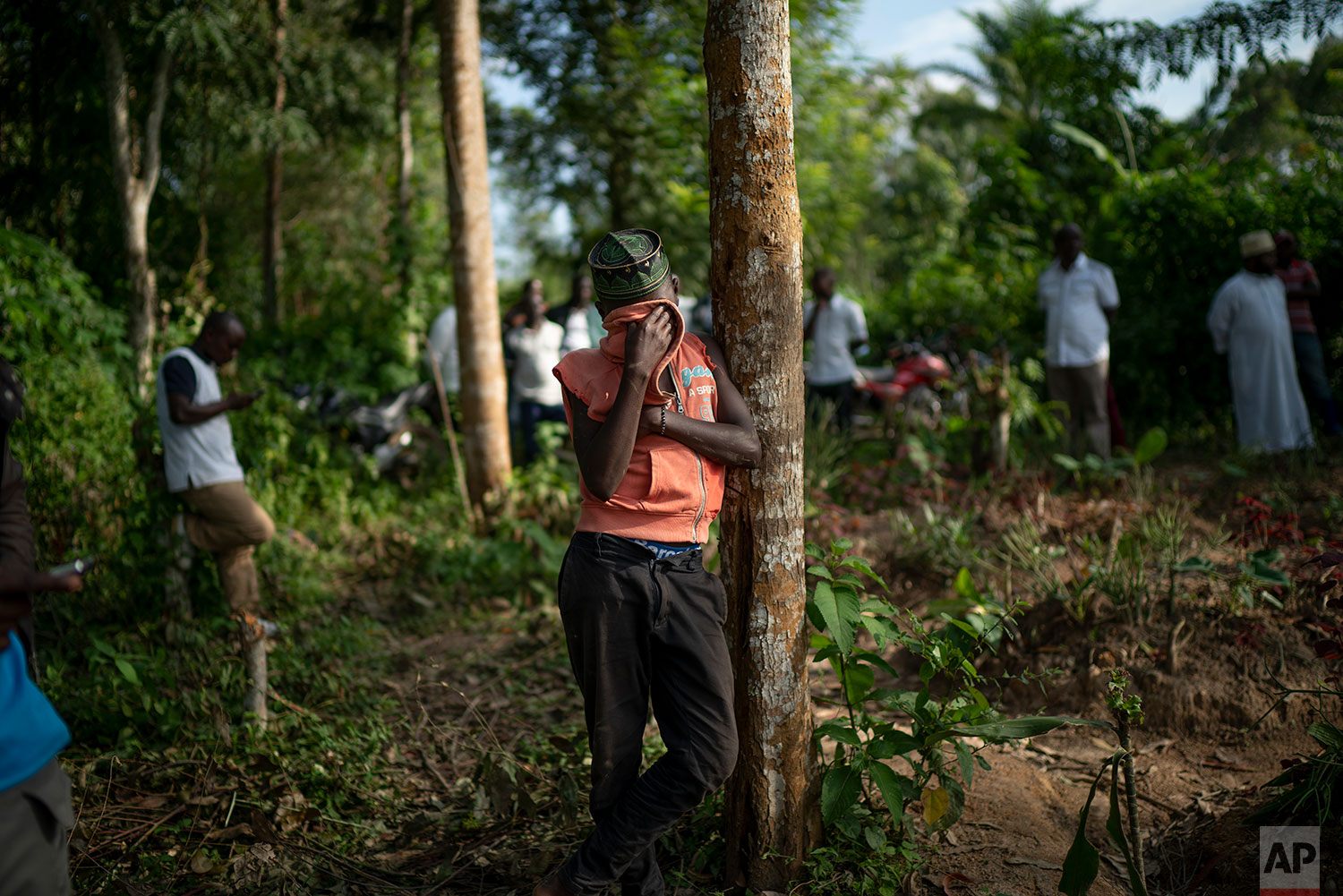 In this July 14, 2019 photo, Ismael Kasereka, 14, weeps at the funeral of his uncle and aunt in Beni, Congo DRC. Mussa Kathembo, an Islamic scholar who had prayed over those who were sick, and his wife Asiya both died of Ebola. (AP Photo/Jerome Delay)