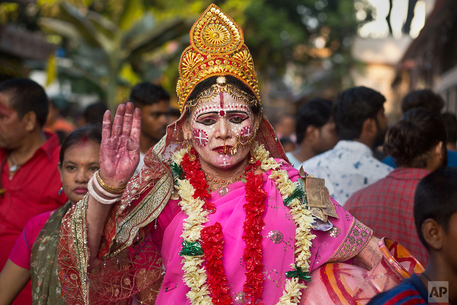 a devotee dressed as goddess Kamakhya attends the Ambubachi festival at the Kamakhya temple in Gauhati, India, June 25, 2019 . The temple is presided over by the goddess Kamakhya, the most important goddess of tantric worship, an esoteric form of Hinduism. The four-day Ambubachi festival is a celebration of Kamakhya's yearly menstrual cycle, and it brings hundreds of thousands of devotees to the temple. (AP Photo/Anupam Nath)