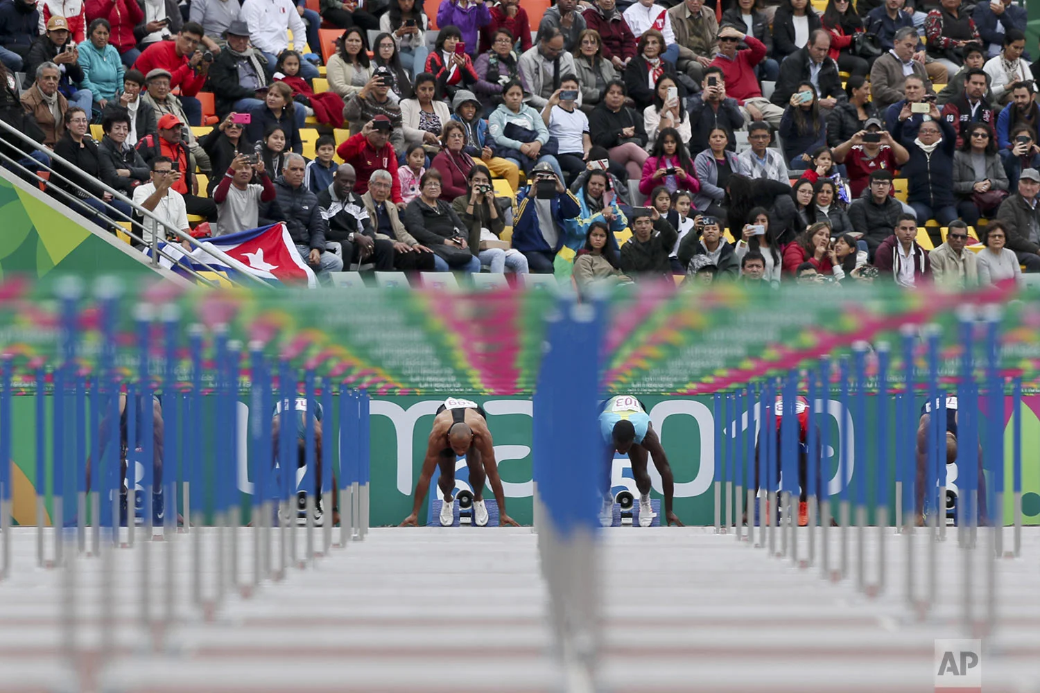 Damian Warner of†Canada, left, and Ken Mullings of†Bahamas prepare to start a men's decathlon 110m hurdles heat during the athletics at the Pan American Games in Lima, Peru, Wednesday, Aug. 7, 2019. (AP Photo/Fernando Llano)
