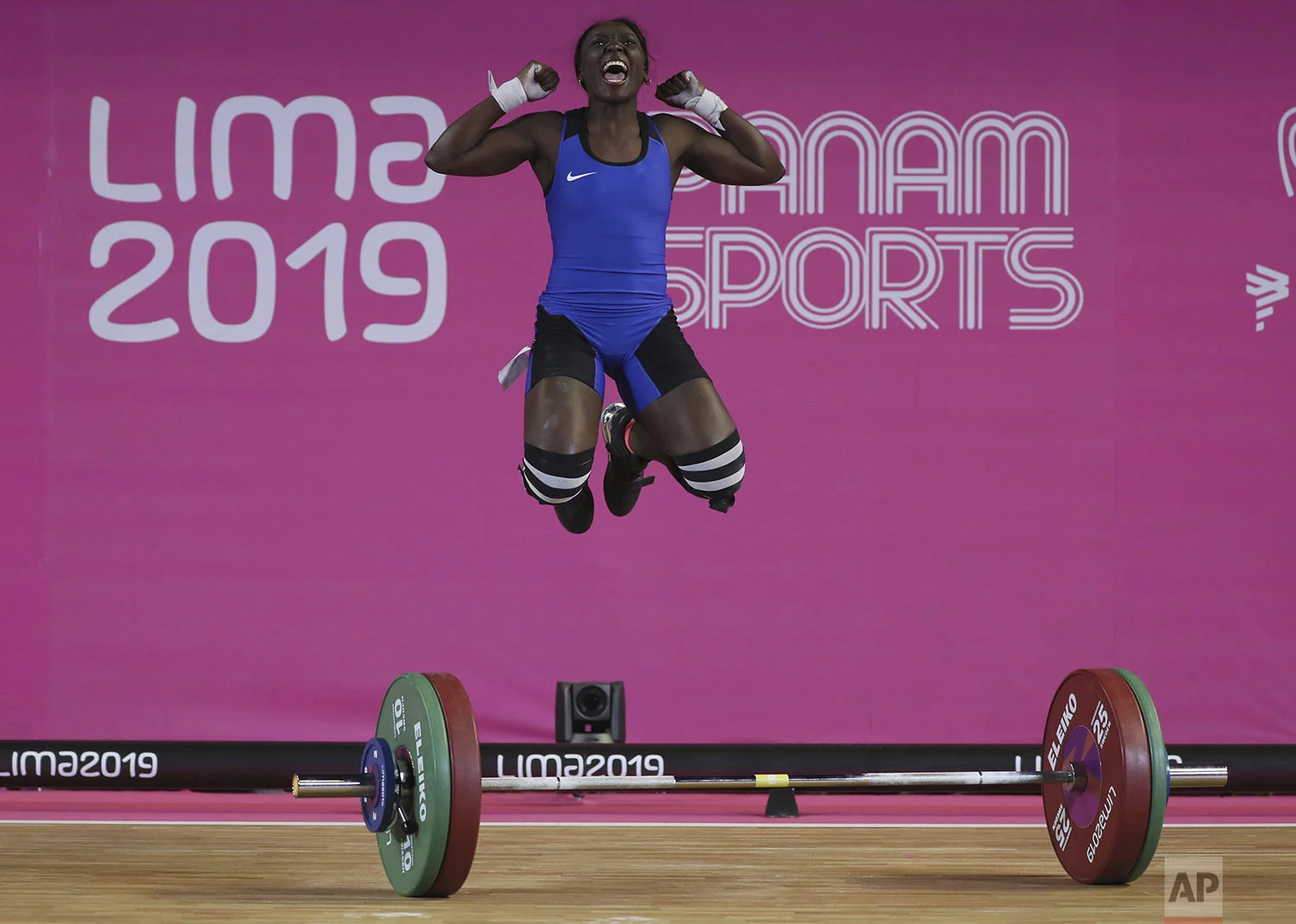 Yenni Sinisterra of Colombia celebrates after lifting 94 kg during the snatch women's weightlifting 55 kg event at the Pan American Games in Lima, Peru, Sunday, July 28, 2019. (AP Photo/Fernando Llano)