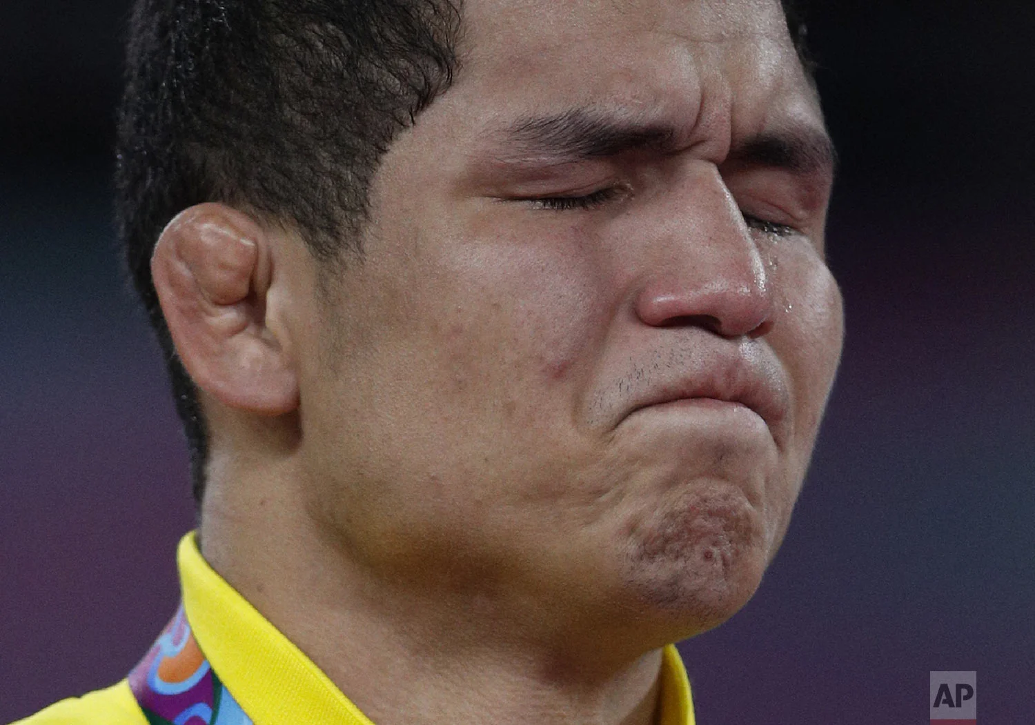 A tear runs down the face of Venezuela's Luis Avendano as he is overcome with emotion after receiving the gold medal for men's 87kg Greco-Roman wrestling at the Pan American Games in Lima, Peru, Wednesday, Aug. 7, 2019. (AP Photo/Rebecca Blackwell)