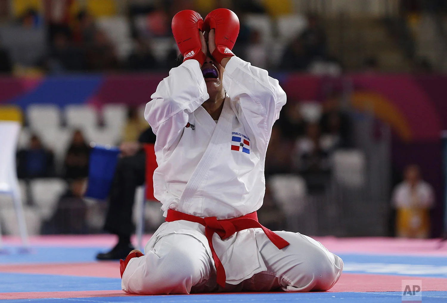 Tanya Rodriguez of the Dominican Republic celebrates after defeating Susana Li of Chile in the women's karate under 68kg gold medal match at the Pan American Games in Lima, Peru, Sunday, Aug. 11, 2019. (AP Photo/Juan Karita)