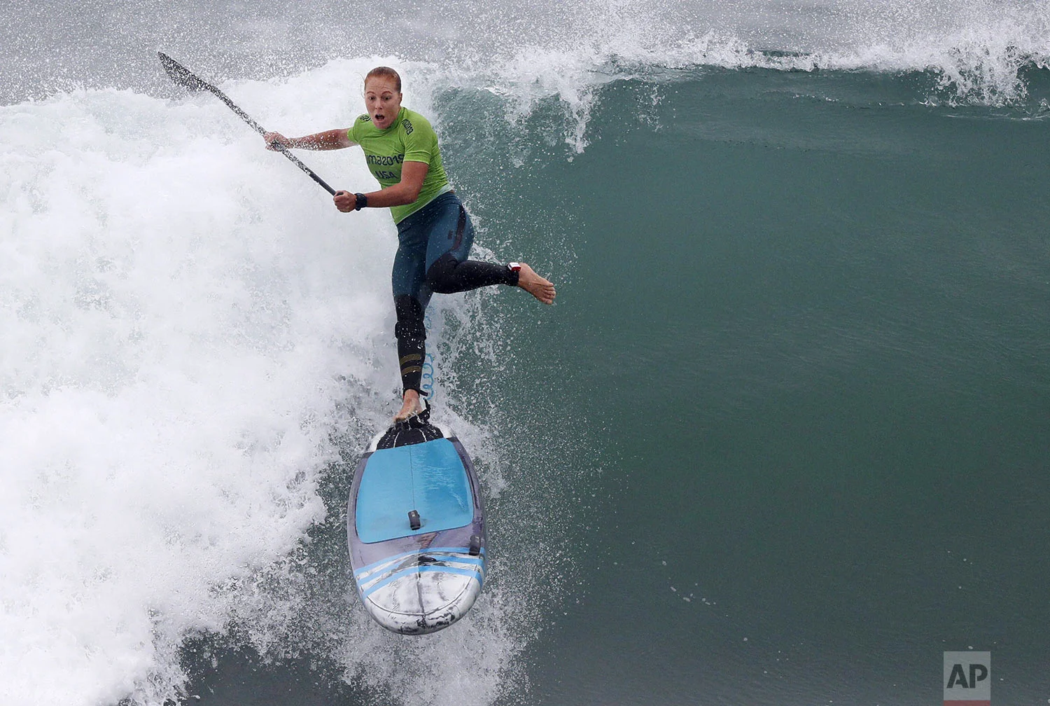 Candice Appleby of the United States rides a wave to win the silver medal in the surfing women's SUP race final during the Pan American Games on Punta Rocas beach in Lima Peru, Friday, Aug.2, 2019. (AP Photo/Silvia Izquierdo)