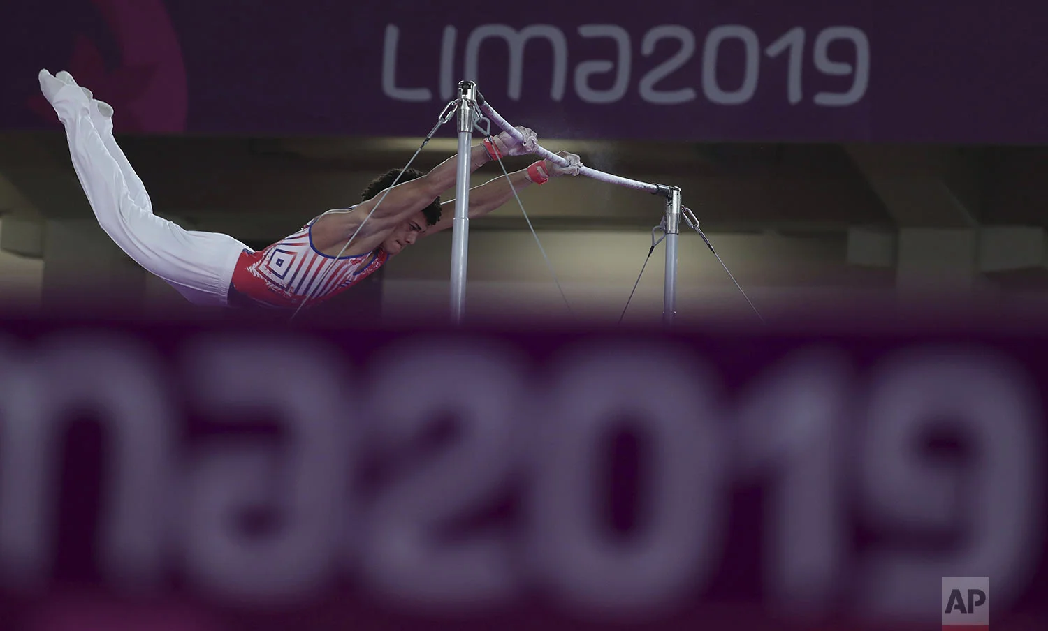 Huber Godoy of Cuba competes on the horizontal bar in the men's artistic gymnastics apparatus at the Pan American Games in Lima, Peru, Wednesday, July 31, 2019. Godoy won the bronze medal. (AP Photo/Fernando Vergara)