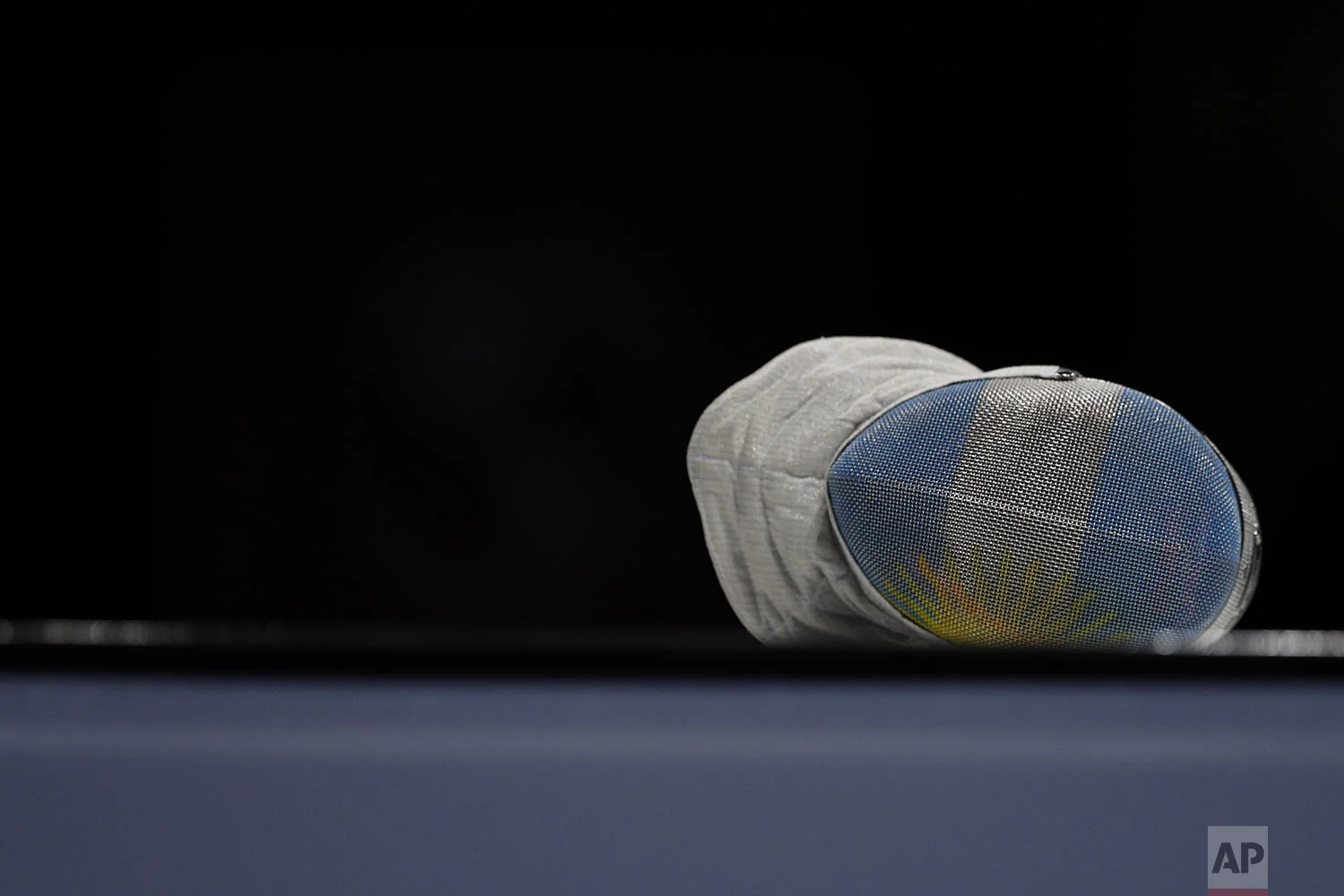 The mask of Argentina's Maria Perez lies on the fencing platform during a pause in her women's sabre individual fencing semifinal against Venezuela's Alejandra Benitez at the Pan American Games in Lima, Peru, Tuesday, Aug. 6, 2019. (AP Photo/Rebecca Blackwell)