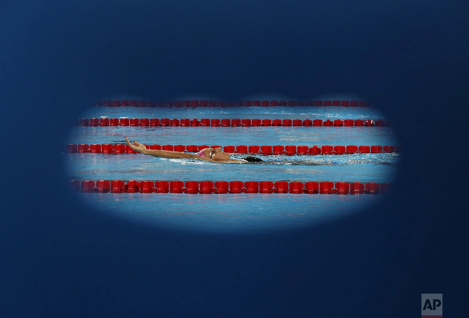 Argentina's Virginia Bardach, who will compete in the women's swimming 200m individual medley, is seen through the cutout of a chair as she warms up before competition at the Pan American Games in Lima, Peru, Saturday, Aug. 10, 2019. (AP Photo/Rebecca Blackwell)