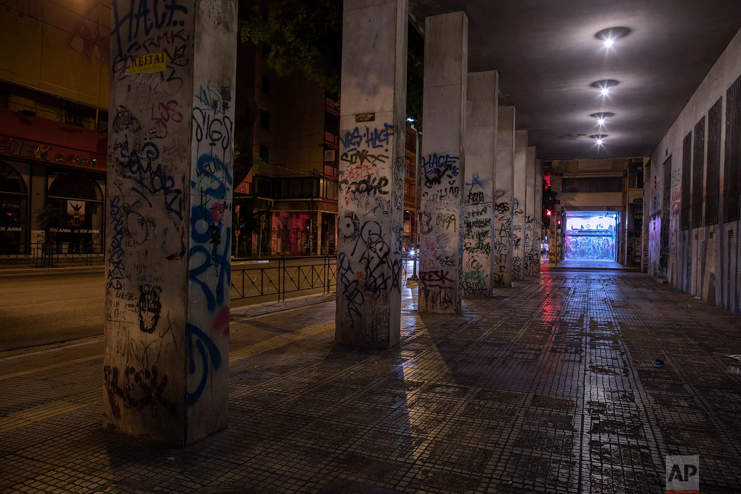 A building and its columns are covered with graffiti in Exarcheia district of Athens, July 25, 2019. (AP Photo/Petros Giannakouris)