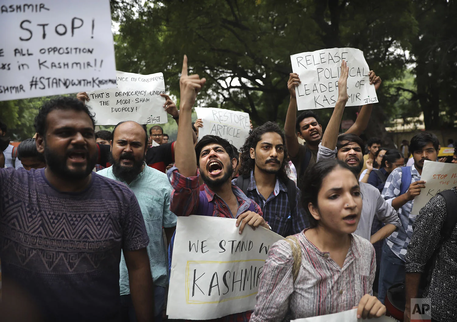 Left party supporters and students shout slogans during a protest against Indian government revoking Kashmir's special constitutional status in New Delhi, India, Monday, Aug. 5, 2019. (AP Photo/Manish Swarup)