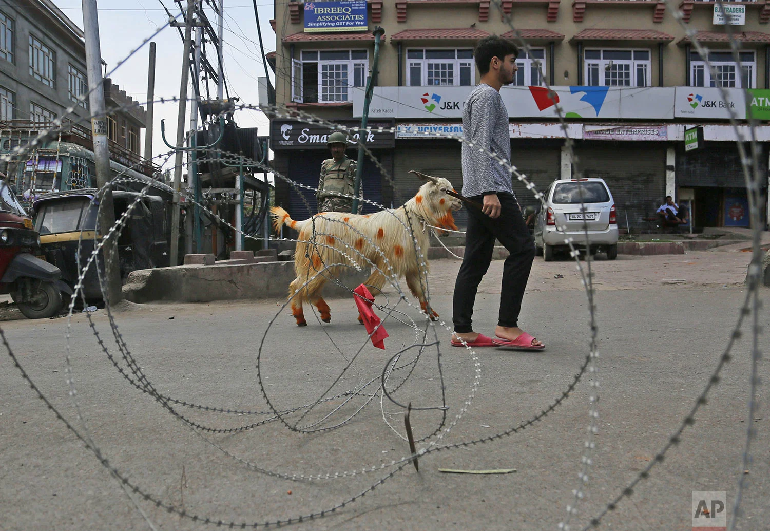 A Kashmiri Muslim civilian crosses a check point ahead of Eid -ul Adha during curfew in Srinagar, Indian controlled Kashmiri, Friday, Aug. 9, 2019. (AP Photo/Mukhtar Khan)
