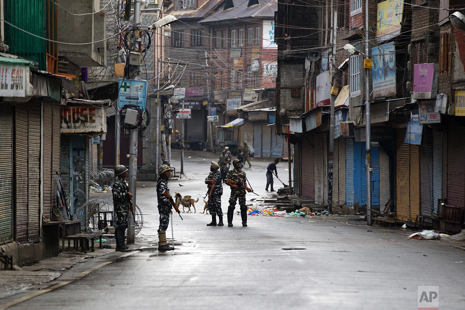 Indian paramilitary soldiers stand guard on a deserted street during curfew in Srinagar, Indian controlled Kashmir, Thursday, Aug. 8, 2019. (AP Photo/Dar Yasin)