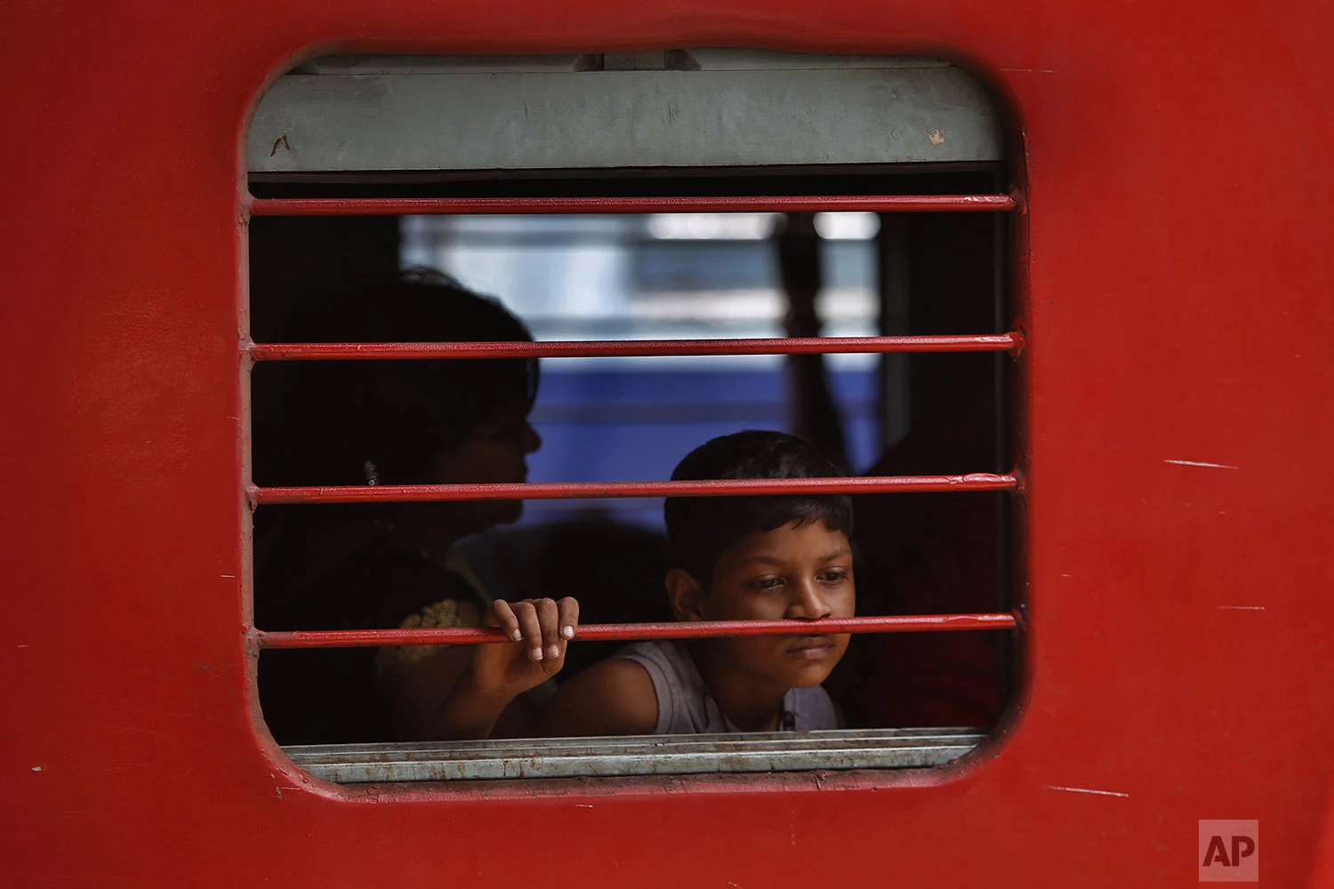 An Indian boy sits inside a train waiting to leave a railway station in Jammu, India, Sunday, Aug. 4, 2019. (AP Photo/Channi Anand)
