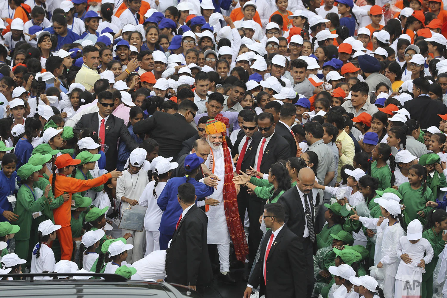Indian Prime Minister Narendra Modi, center, greets school children after addressing the nation on the country's Independence Day from the ramparts of Mughal-era Red Fort, in New Delhi, India, Thursday, Aug. 15, 2019. (AP Photo/Manish Swarup)