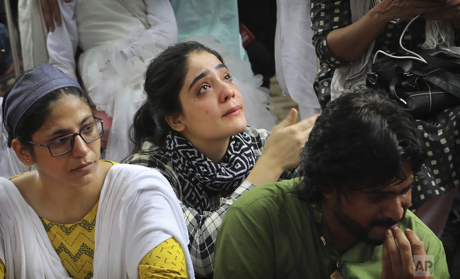 A Kashmiri woman breaks down after listening to a fellow Kashmiri narrating memories of past Eid in the valley as Kashmiris living in New Delhi gather for a function to observe Eid al-Adha away from their homes in New Delhi, India, Monday, Aug. 12, 2019. (AP Photo/Manish Swarup)
