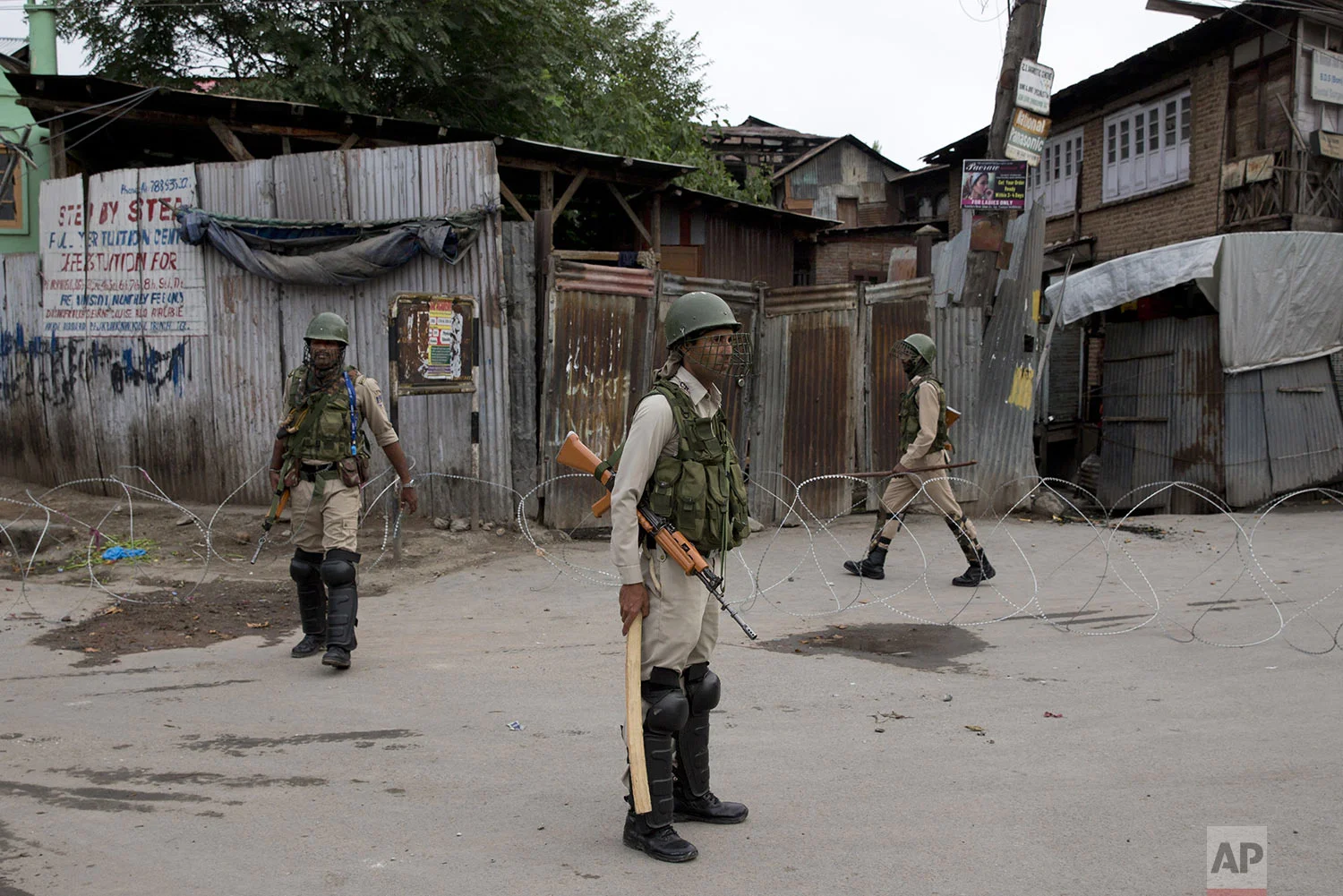 Indian paramilitary soldiers stand guard during security lockdown in Srinagar, Indian controlled Kashmir, Sunday, Aug. 18, 2019. (AP Photo/ Dar Yasin)