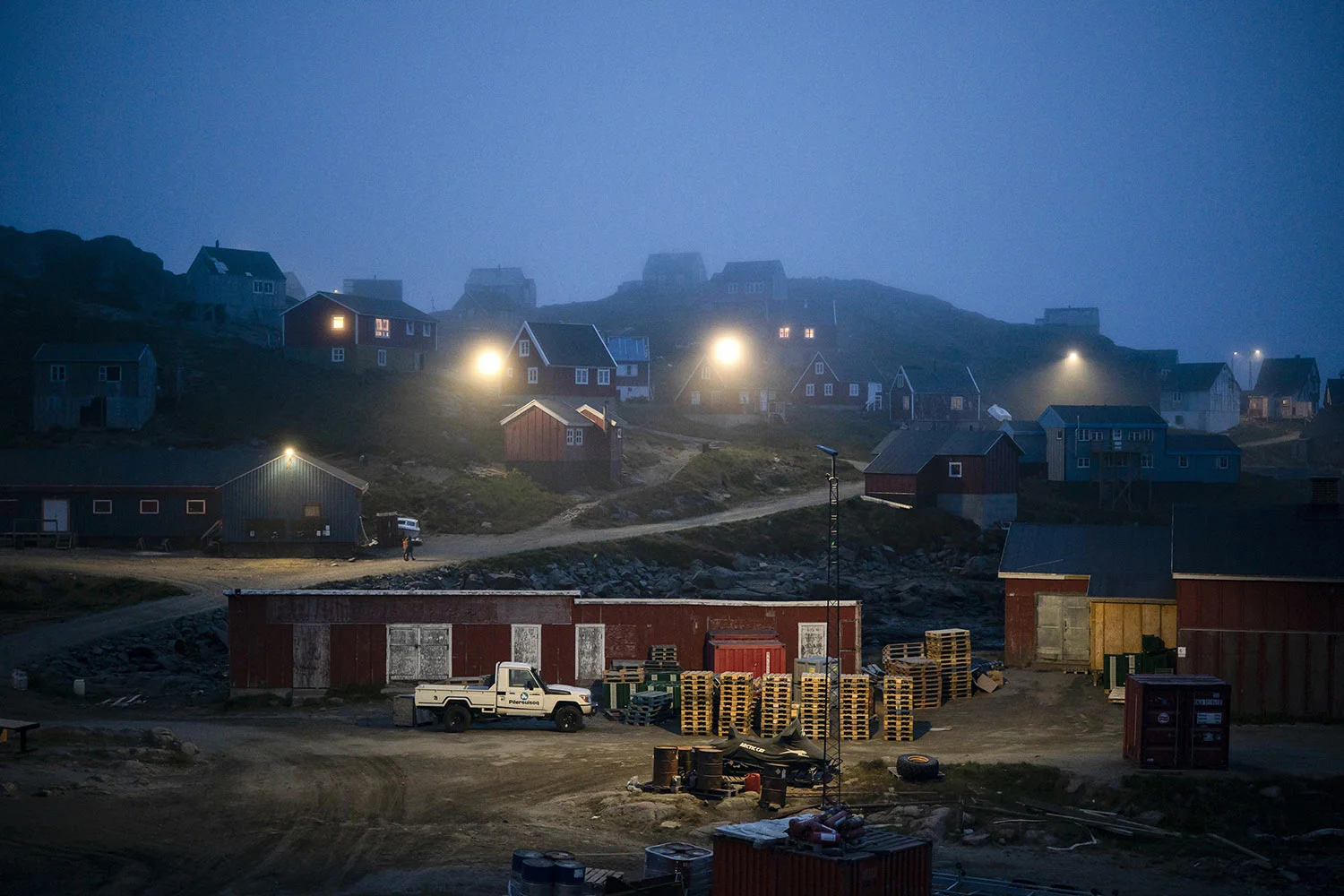Early morning fog shrouds homes on Aug. 15, 2019, in Kulusuk, Greenland. In tiny Kulusuk, resident Mugu Utuaq says the winter that used to last as long as 10 months when he was a boy, can now be as short as five months. Scientists are hard at work in Greenland, trying to understand the alarmingly rapid melting of the ice. (AP Photo/Felipe Dana)