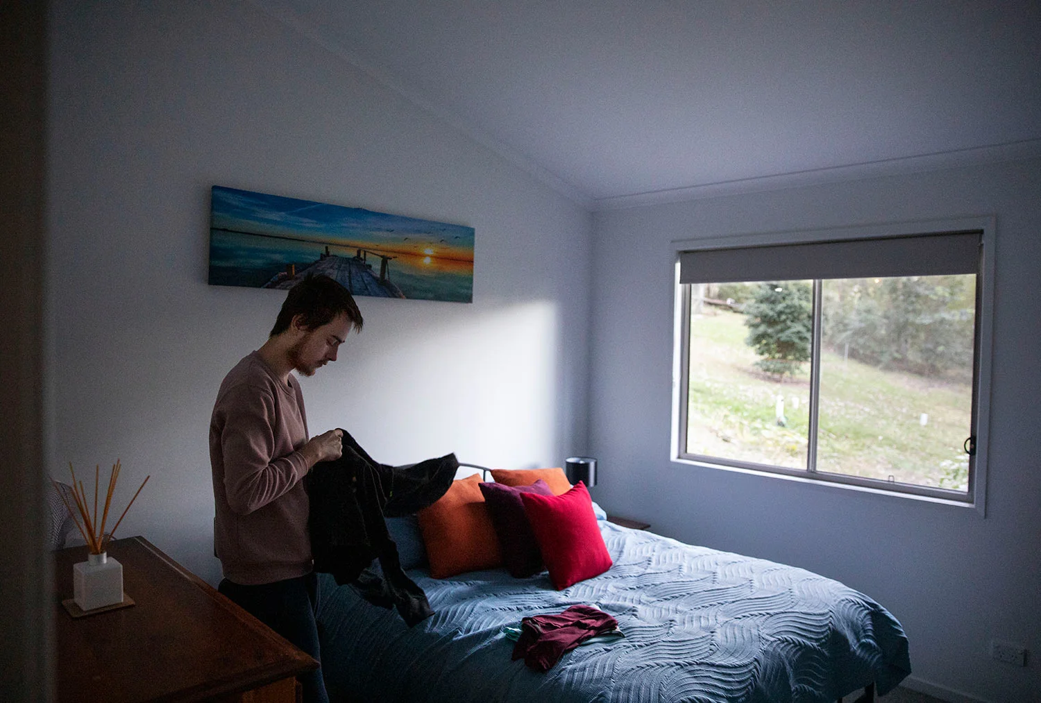 Sam Ware, 22, packs some clothes from his mother's home upon returning for the first time since overdosing there three weeks ago, in Fountaindale, Central Coast, Australia, Friday, July 19, 2019. (AP Photo/David Goldman)