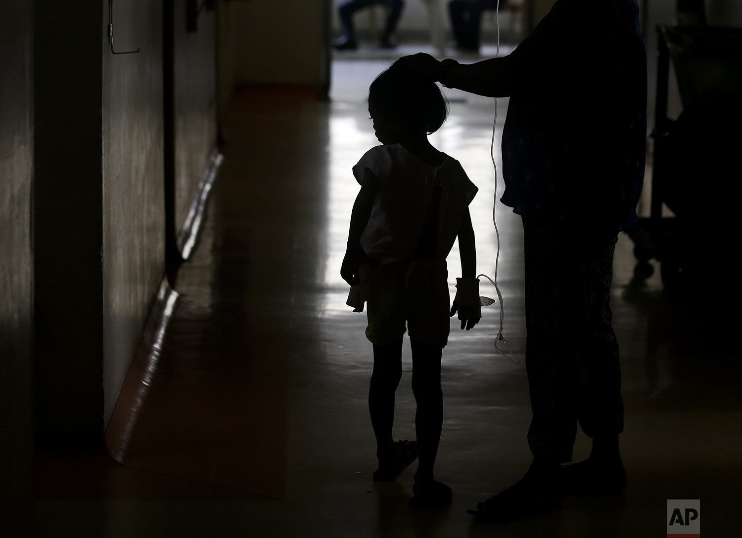  A young dengue patient walks inside the San Lazaro government hospital in Manila, Philippines on Wednesday, Aug. 7, 2019.  (AP Photo/Aaron Favila) 