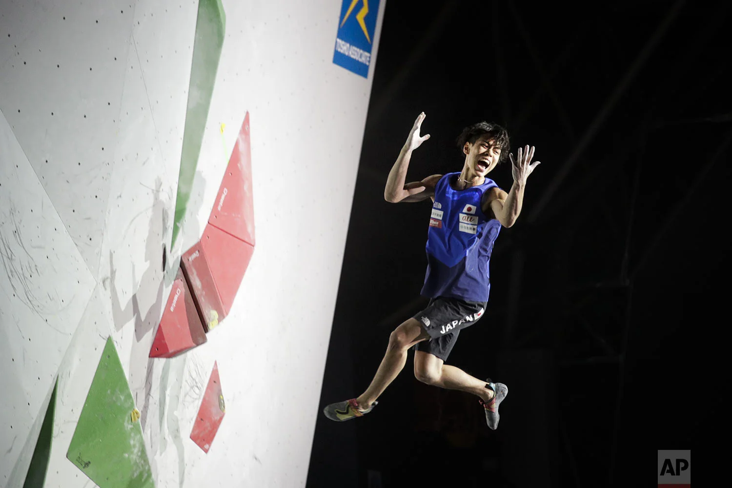 Kai Harada, of Japan, reacts as he falls from a bouldering wall during the men's combined bouldering final at the International Federation of Sport Climbing World Championships, in Tokyo, Wednesday, Aug. 21, 2019. (AP Photo/Jae C. Hong)
