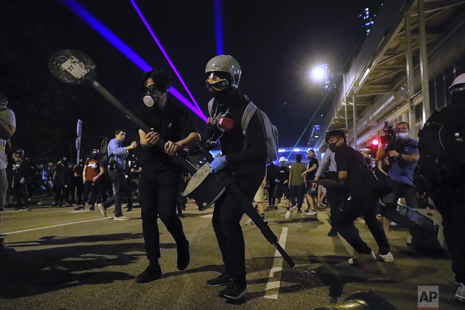 Demonstrators stand outside the Yuen Long MTR station during a protest in Hong Kong, Wednesday, Aug. 21, 2019. (AP Photo/Kin Cheung)