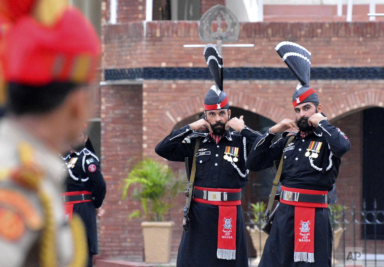 Pakistan Rangers soldiers face Indian Border Security Force soldiers at a daily closing ceremony on the Indian side of the Attari-Wagah border, Friday, Aug. 9, 2019. (AP Photo/Prabhjot Gill)