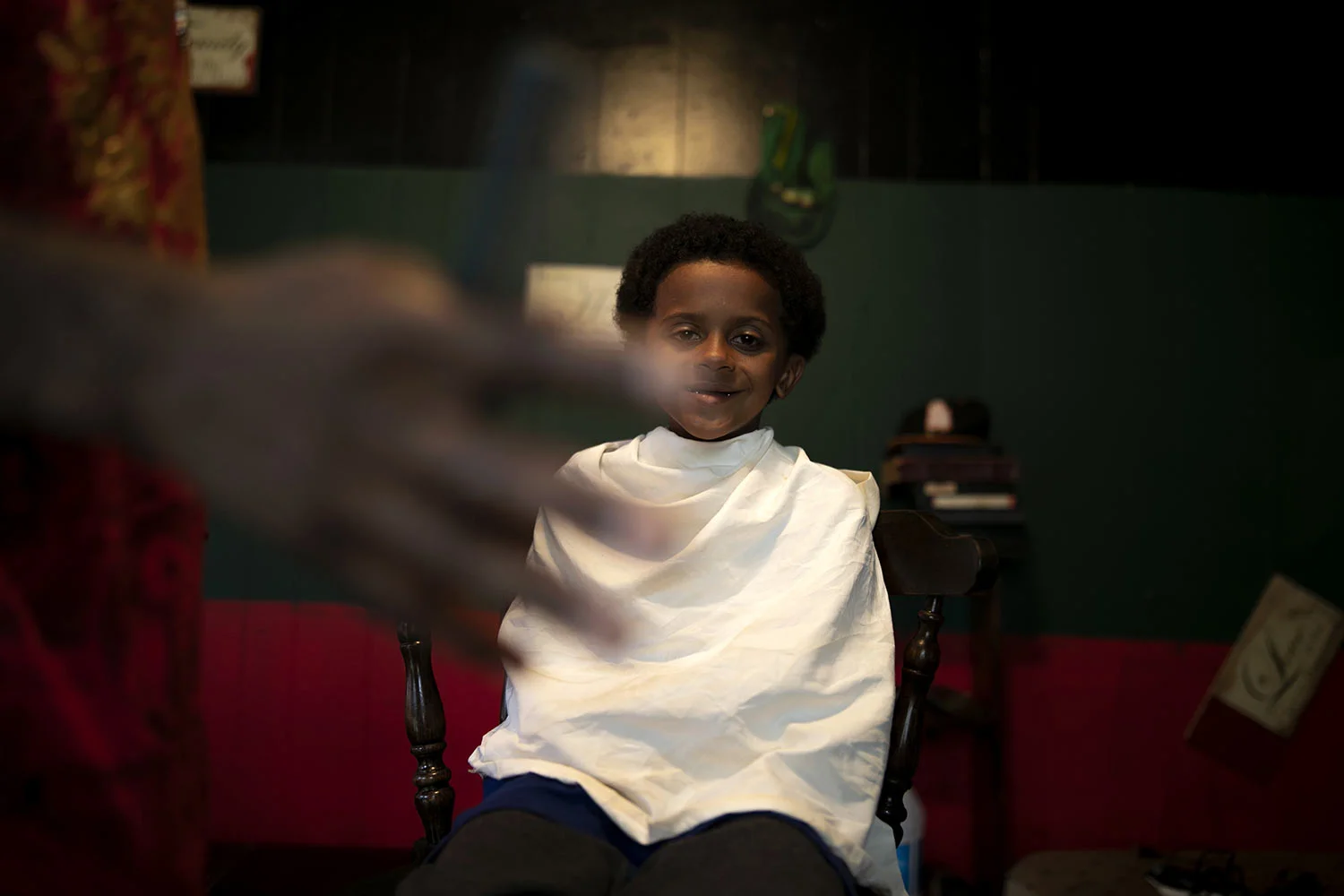 Jintarius Turner Love, 7, grins while getting a haircut from his uncle, Joshua K. Love at his home in Greenwood, Miss., Saturday, June 8, 2019. (AP Photo/Wong Maye-E)