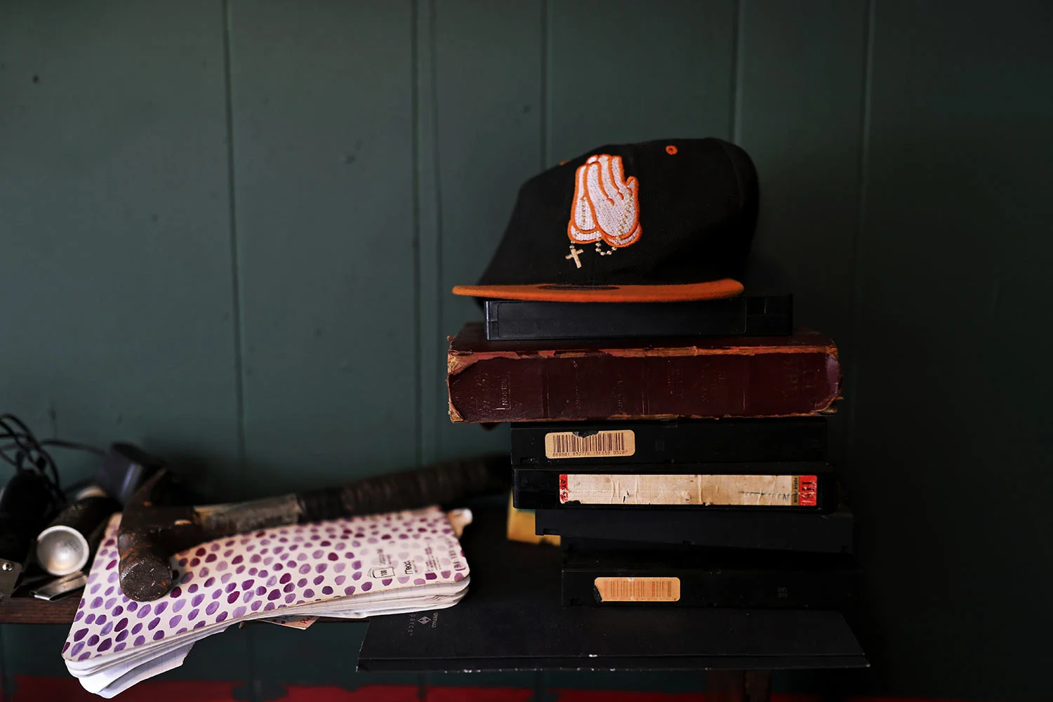 A cap embroidered with prayer hands sits on a shelf in Joshua K. Love's living room at his home in Greenwood, Miss., Saturday, June 8, 2019. Love says he prays and believes in God, even though he was allegedly sexually abused at a local Catholic grade school. (AP Photo/Wong Maye-E)