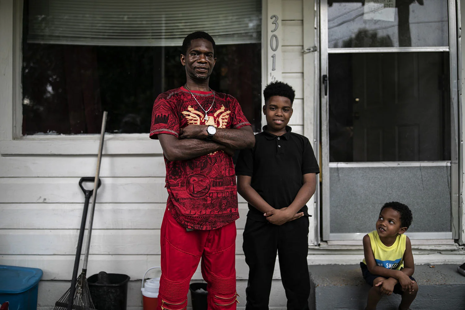 Joshua K. Love with his son, Joshua K. Love Jr., and his nephew, Mason Martinez, on the front porch of his home in Greenwood, Miss., Saturday, June 8, 2019. Joshua Love Sr. says he was sexually abused by two Franciscan friars at a local Catholic grade school. (AP Photo/Wong Maye-E)