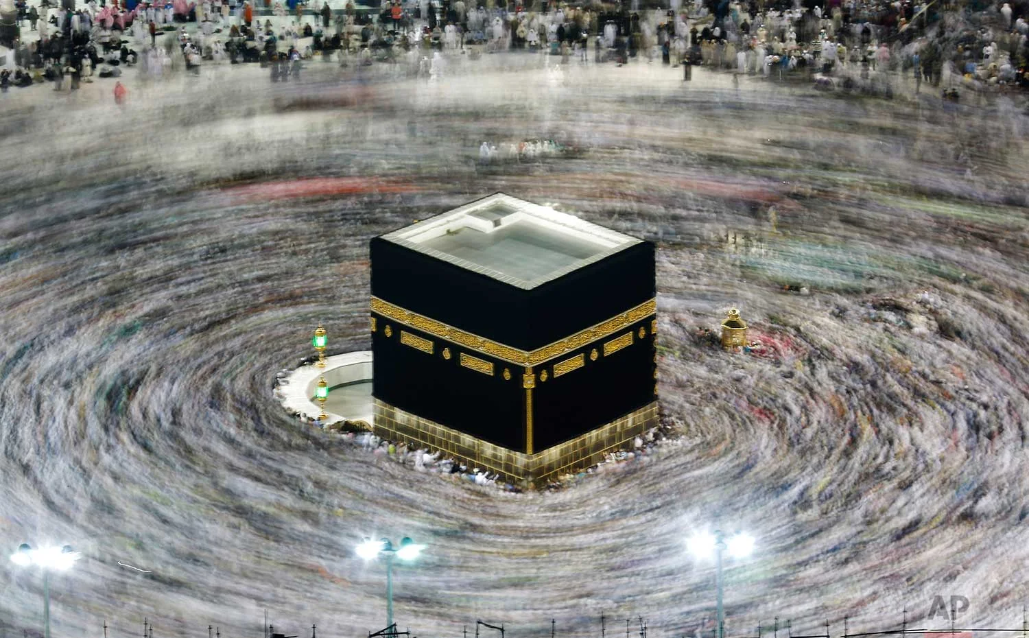 In this picture taken with slow shutter speed, Muslim pilgrims circumambulate the Kaaba, the cubic building at the Grand Mosque, durning the hajj pilgrimage in the Muslim holy city of Mecca, Saudi Arabia, Tuesday, Aug. 13, 2019. The pilgrimage to Mecca is required once in a lifetime of every Muslim who can afford it and is physically able to make it. (AP Photo/Amr Nabil)